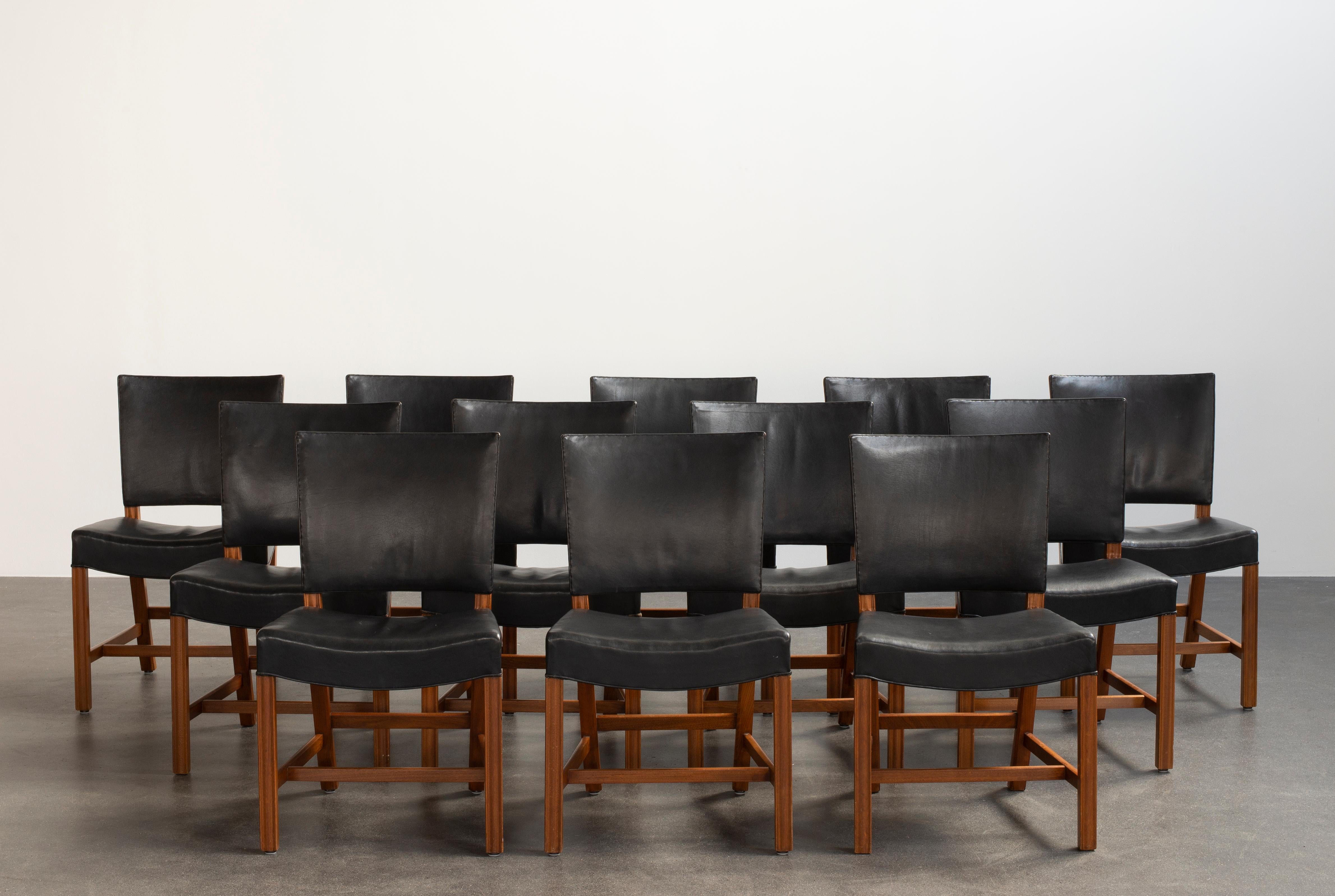 Kaare Klint set of 12 Red chairs in mahogany and leather. Executed by Rud. Rasmussen.