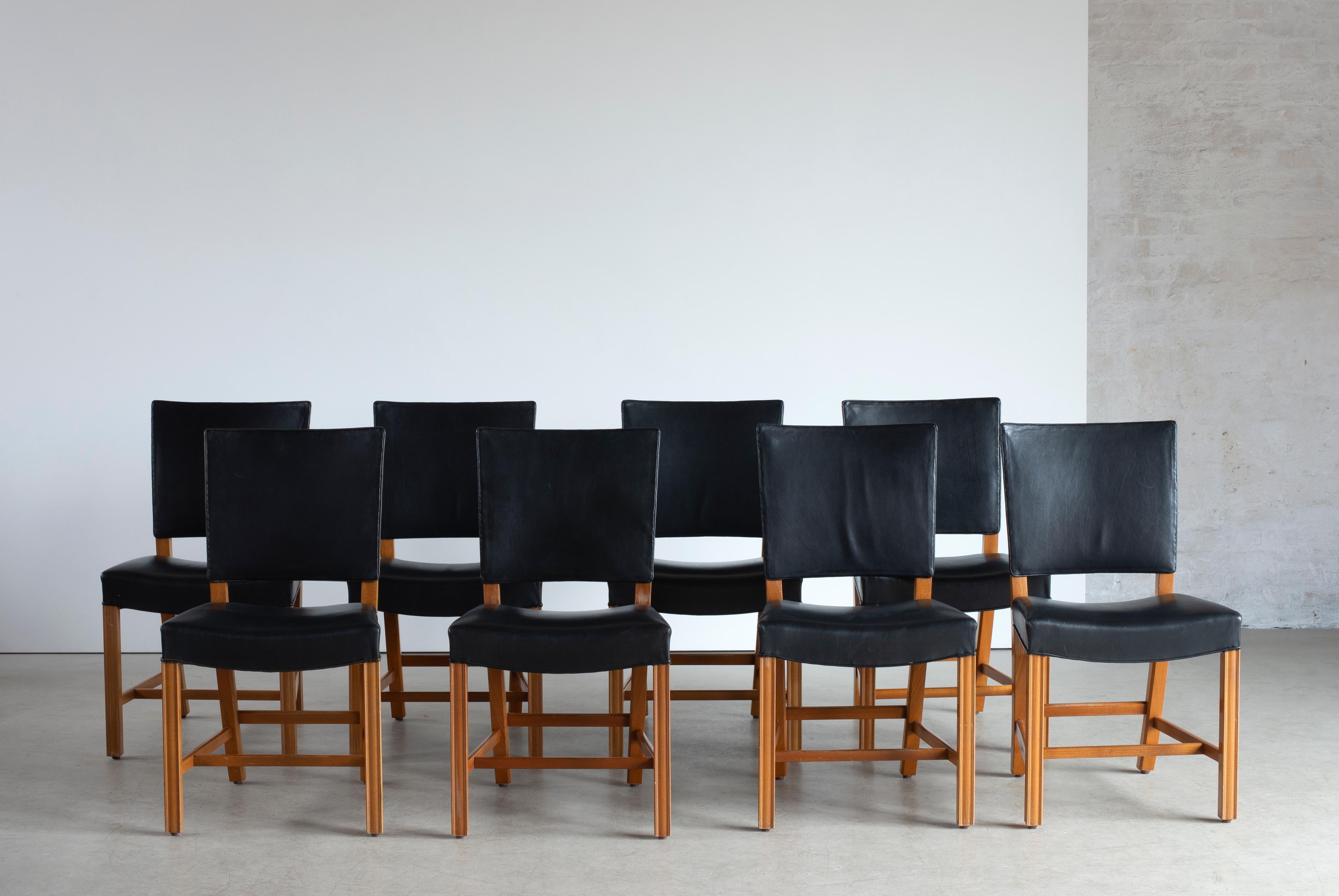 Kaare Klint set of eight red chairs in mahogany, upholstered with black leather. Executed by Rud. Rasmussen.