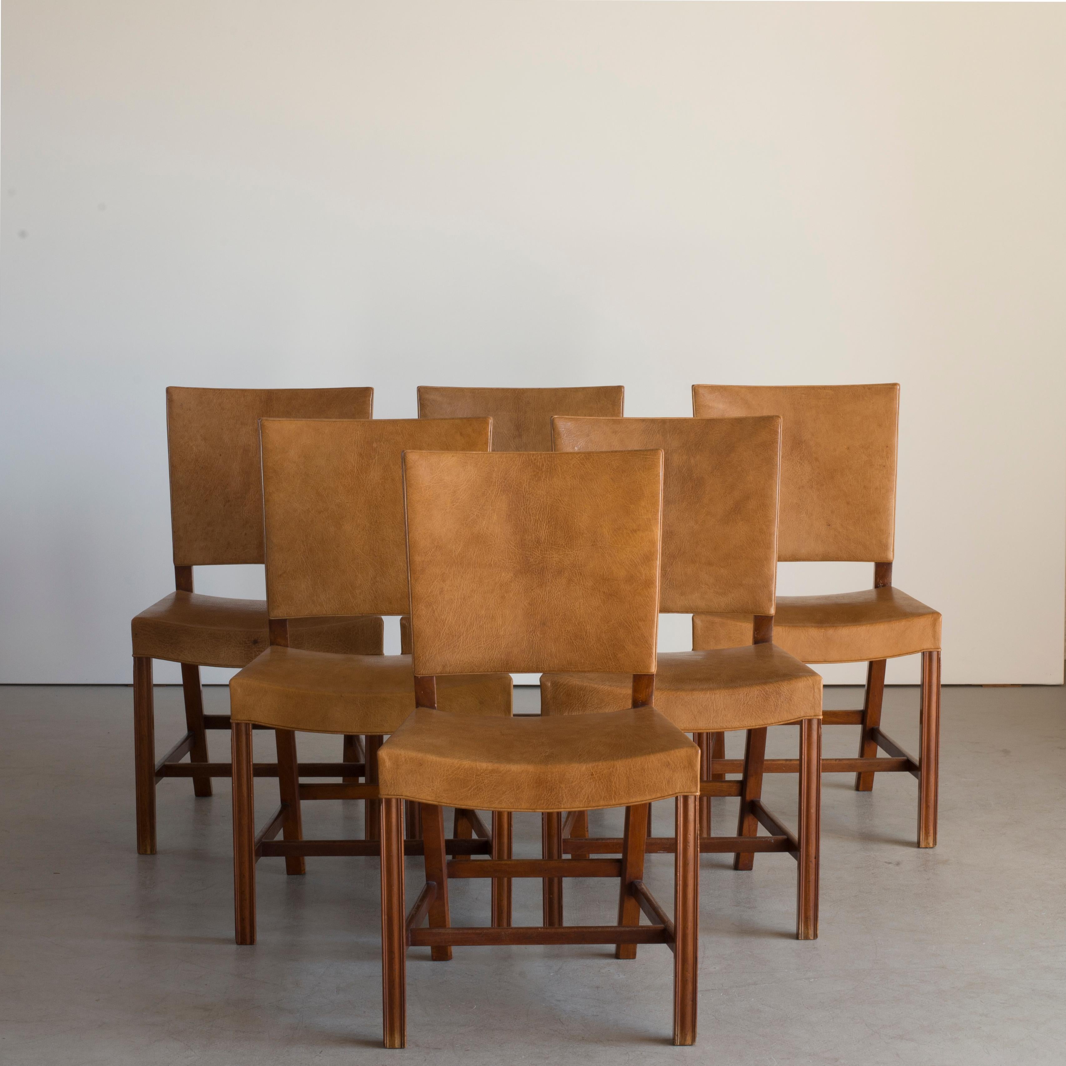 Kaare Klint set of six red chairs. Executed by Rud. Rasmussen, 1930-1934

Mahogany and Niger leather.

Underside with manufacturer's paper label RUD. RASMUSSENS/SNEDKERIER/45 NØRREBROGAD/KØBENHAVN, penciled number and architect's monogrammed paper