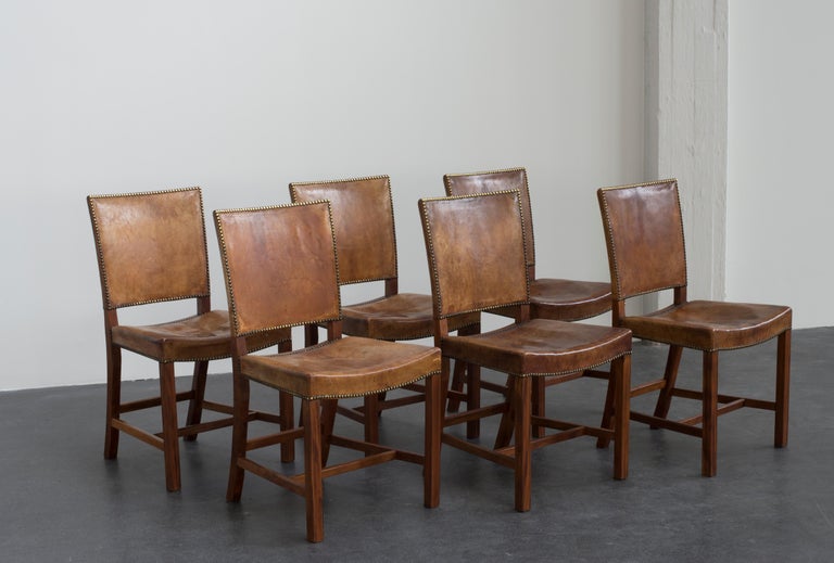 Kaare Klint set of six red chairs. Executed by Rud. Rasmussen.

Mahogany, Niger leather and brass.

Underside with manufacturer's paper label.