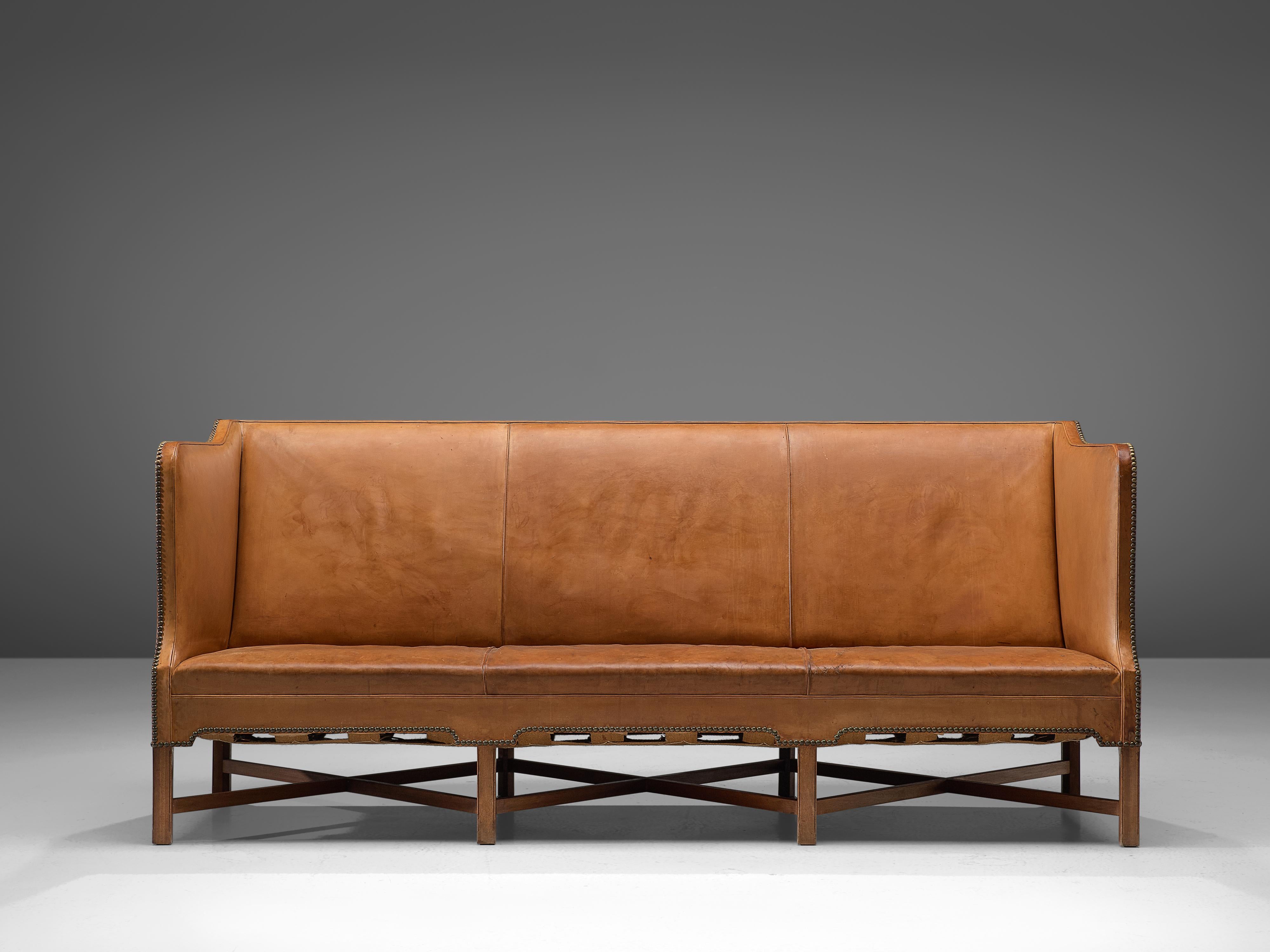 Kaare Klint for Rud Rasmussen, sofa model 4118, original leather and mahogany, Denmark, 1929.

Classic and elegant Scandinavian three-seat sofa model 4118 by Kaare Klint. This model was designed in 1929. The base consists of eight legs in mahogany