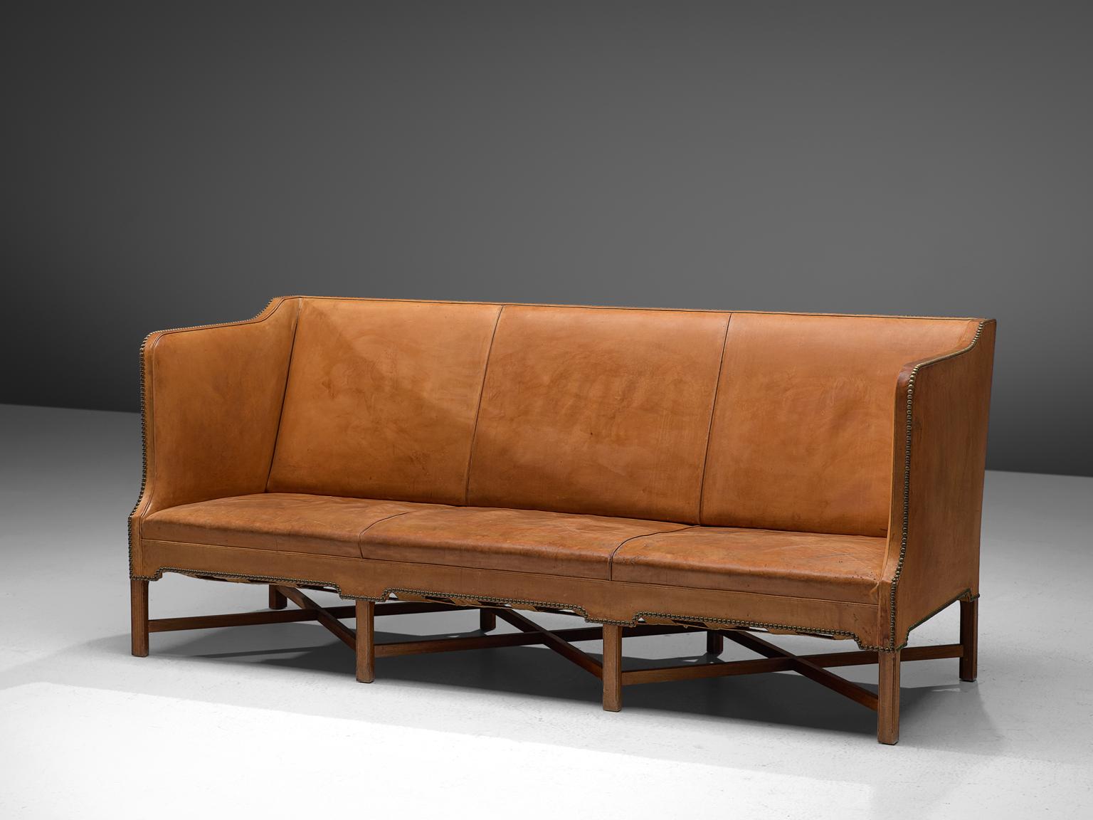 Kaare Klint for Rud Rasmussen, sofa model 4118, original leather and mahogany, Denmark, 1929.

Classic and elegant Scandinavian three-seater sofa model 4118 by Kaare Klint. This model was designed in 1929. The base consists of eight legs in