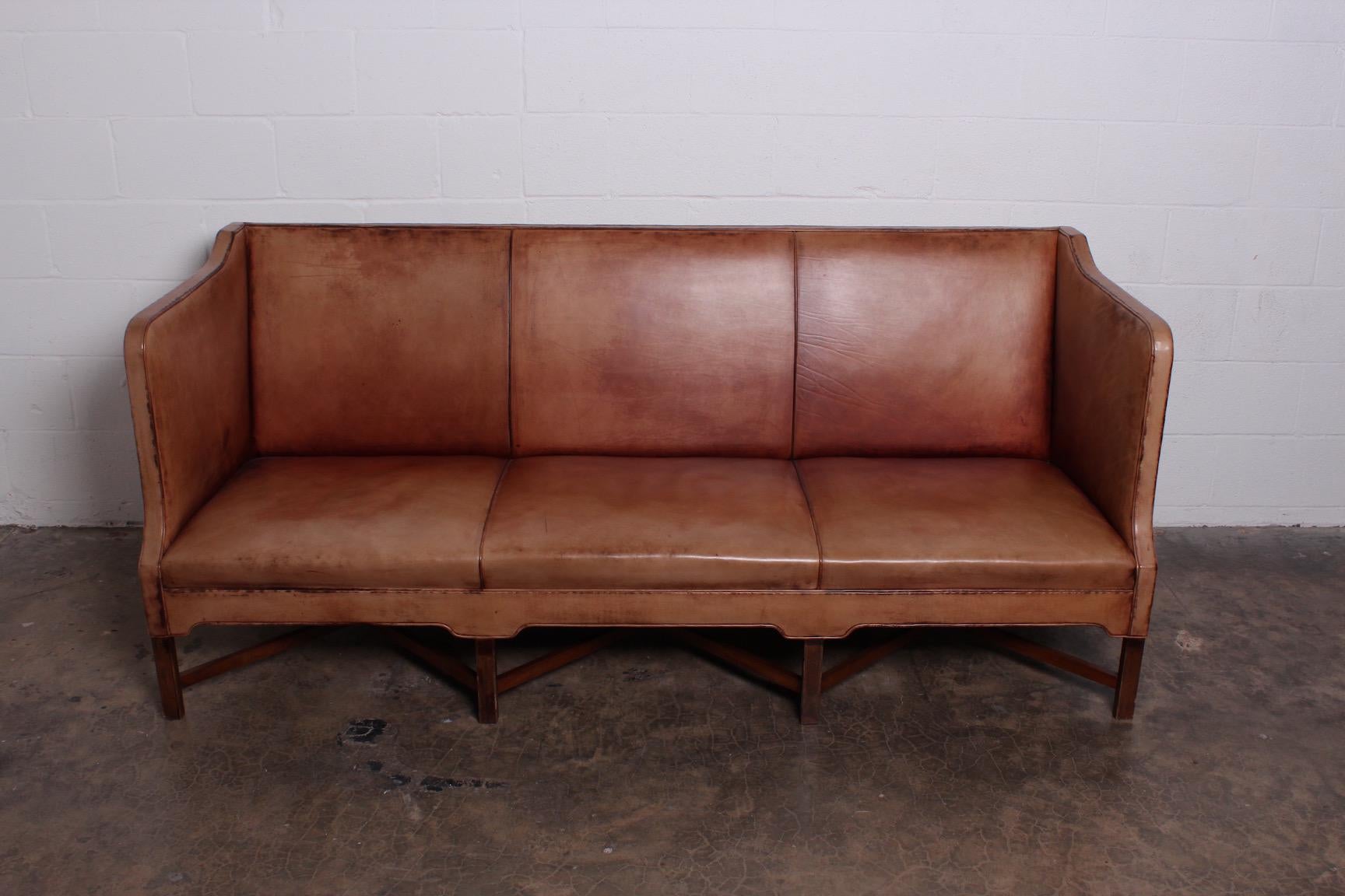 Beautiful Kaare Klint sofa model 4118 with mahogany base and patinated leather.