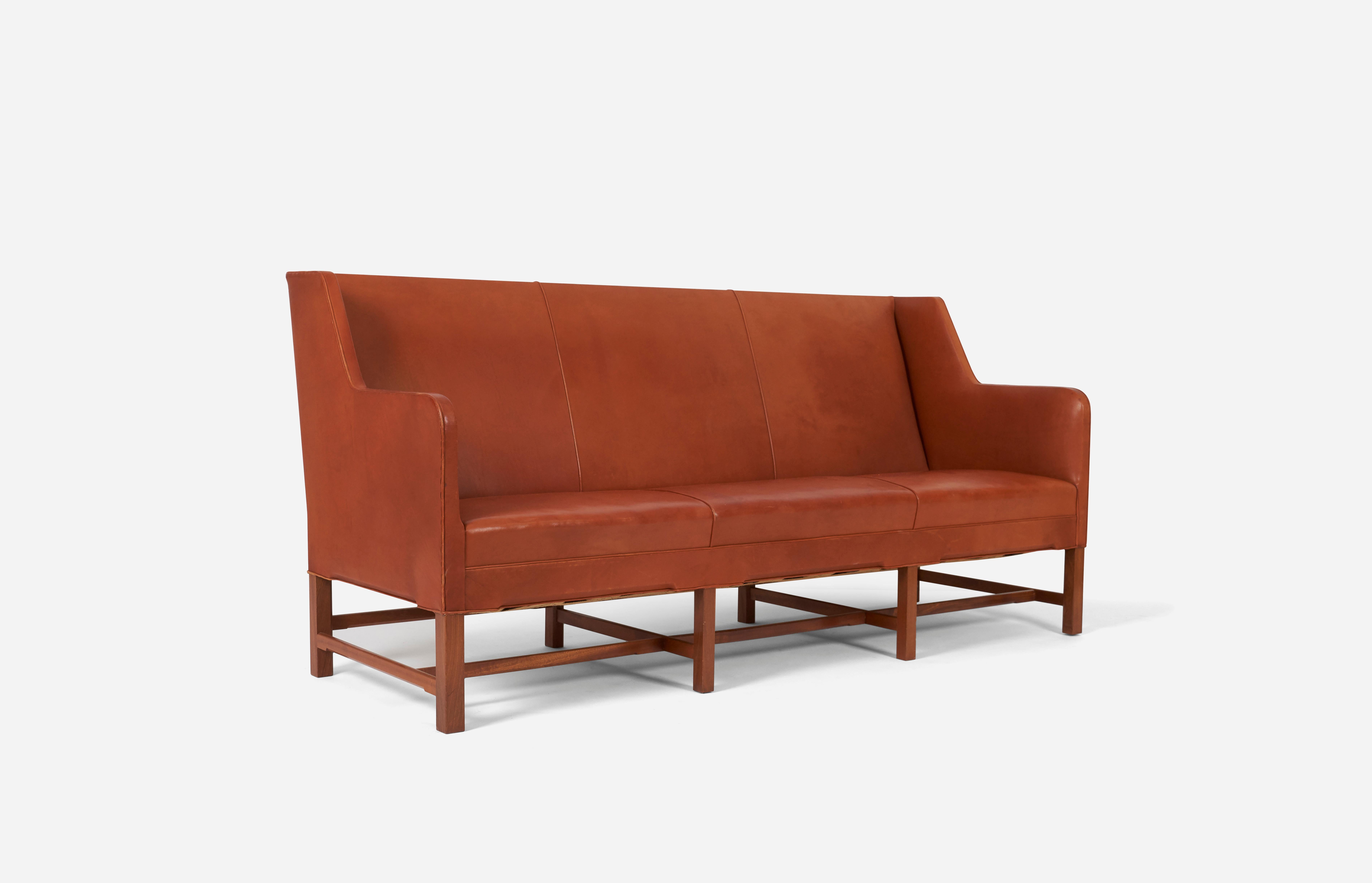 Kaare Klint sofa designed in 1935 and produced by cabinetmaker Rud Rasmussen. Sofa Model KK 5011. Original orange/red leather with mahogany frame.