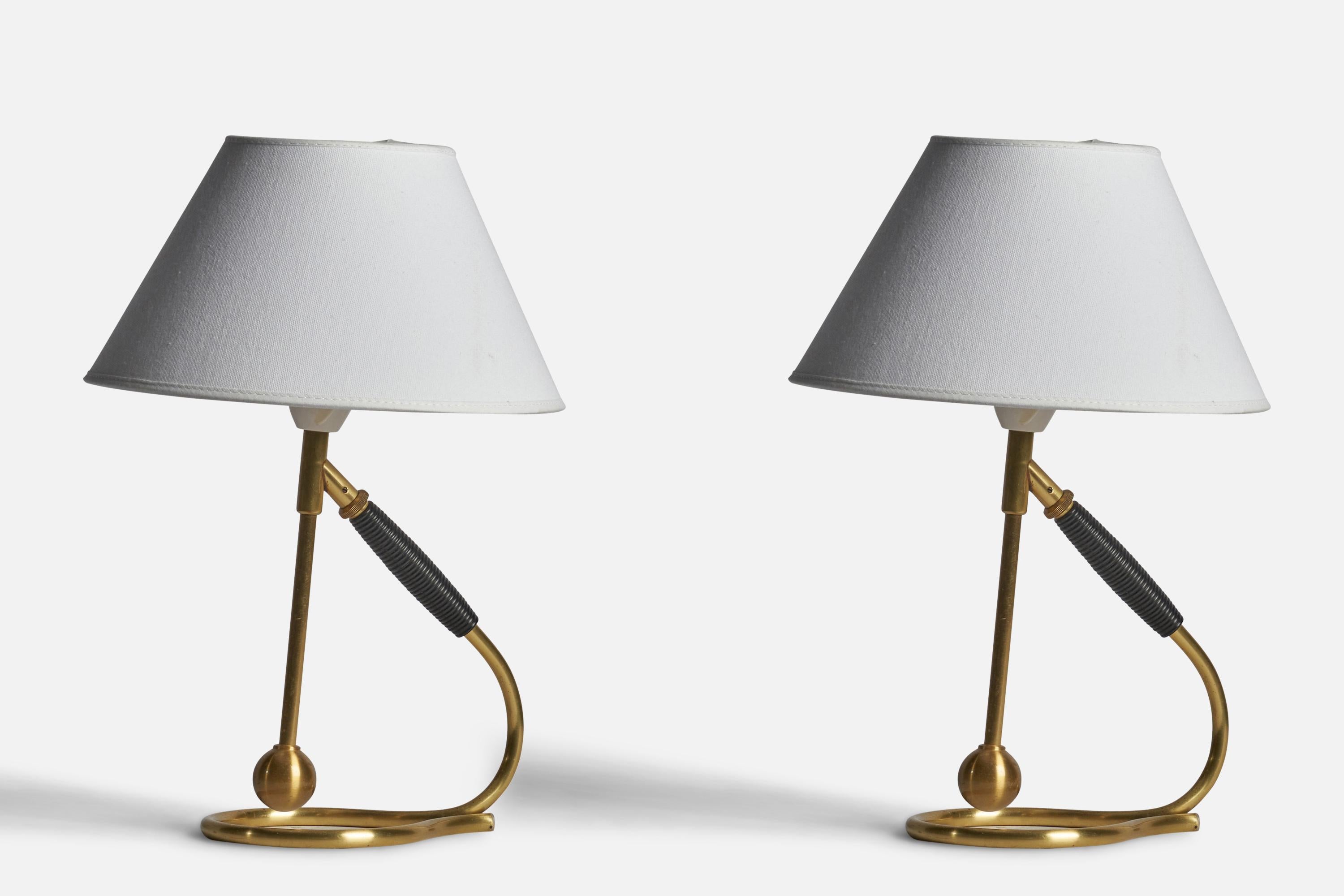 A pair of adjustable brass and rubber table or wall lights designed by Kaare Klint and produced by Le Klint, Denmark, c. 1950s.

Dimensions of Lamp (inches): 11.4”H x 4.7” W x 7” D
Dimensions of Shade (inches): 4.5” Top Diameter x 10” Bottom