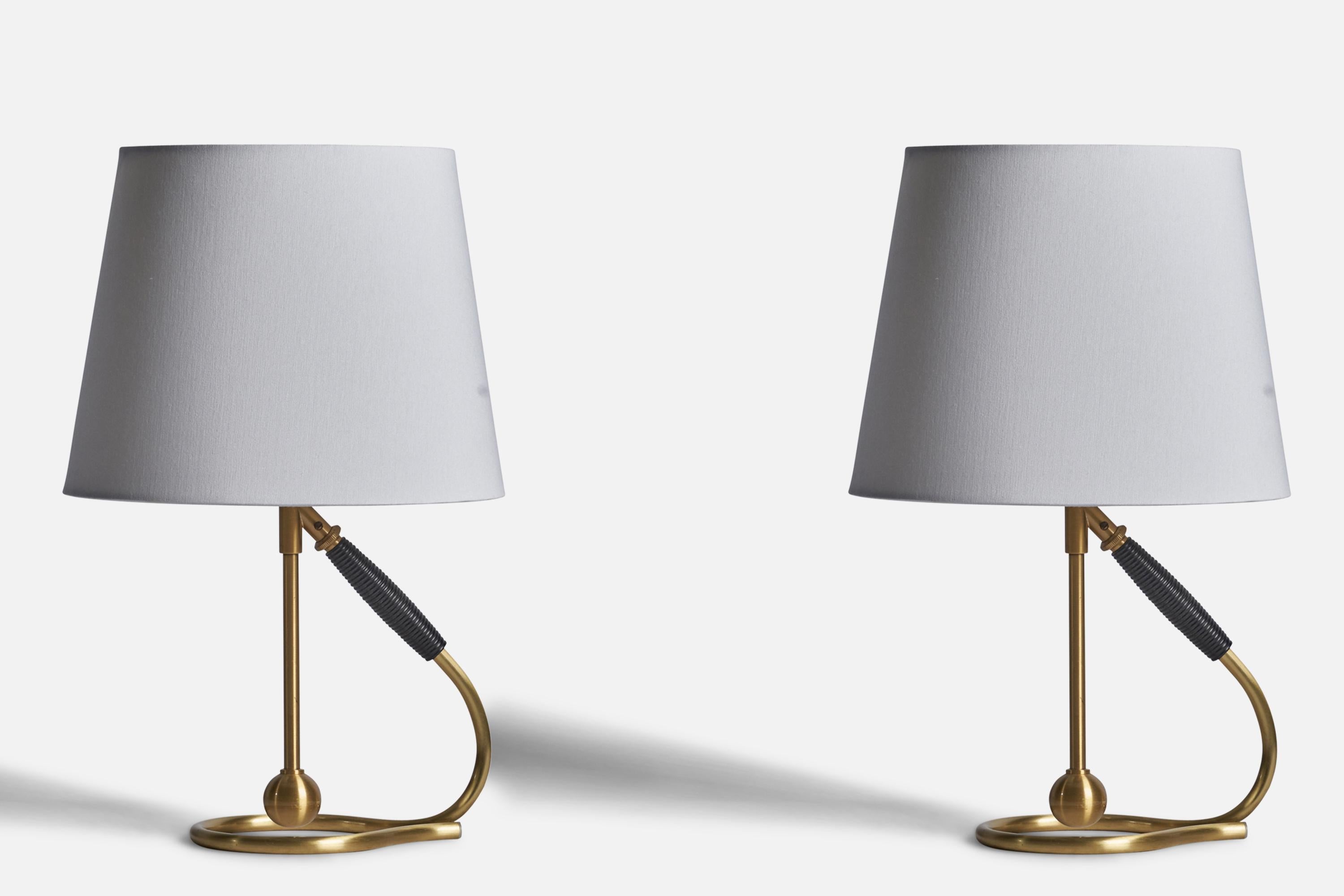 A pair of adjustable brass and rubber table or wall lights designed by Kaare Klint and produced by Le Klint, Denmark, c. 1950s.

Dimensions of Lamp (inches): 11.5” H x 4.75” W x 7” D
Dimensions of Shade (inches): 7.5” Top Diameter x 10” Bottom