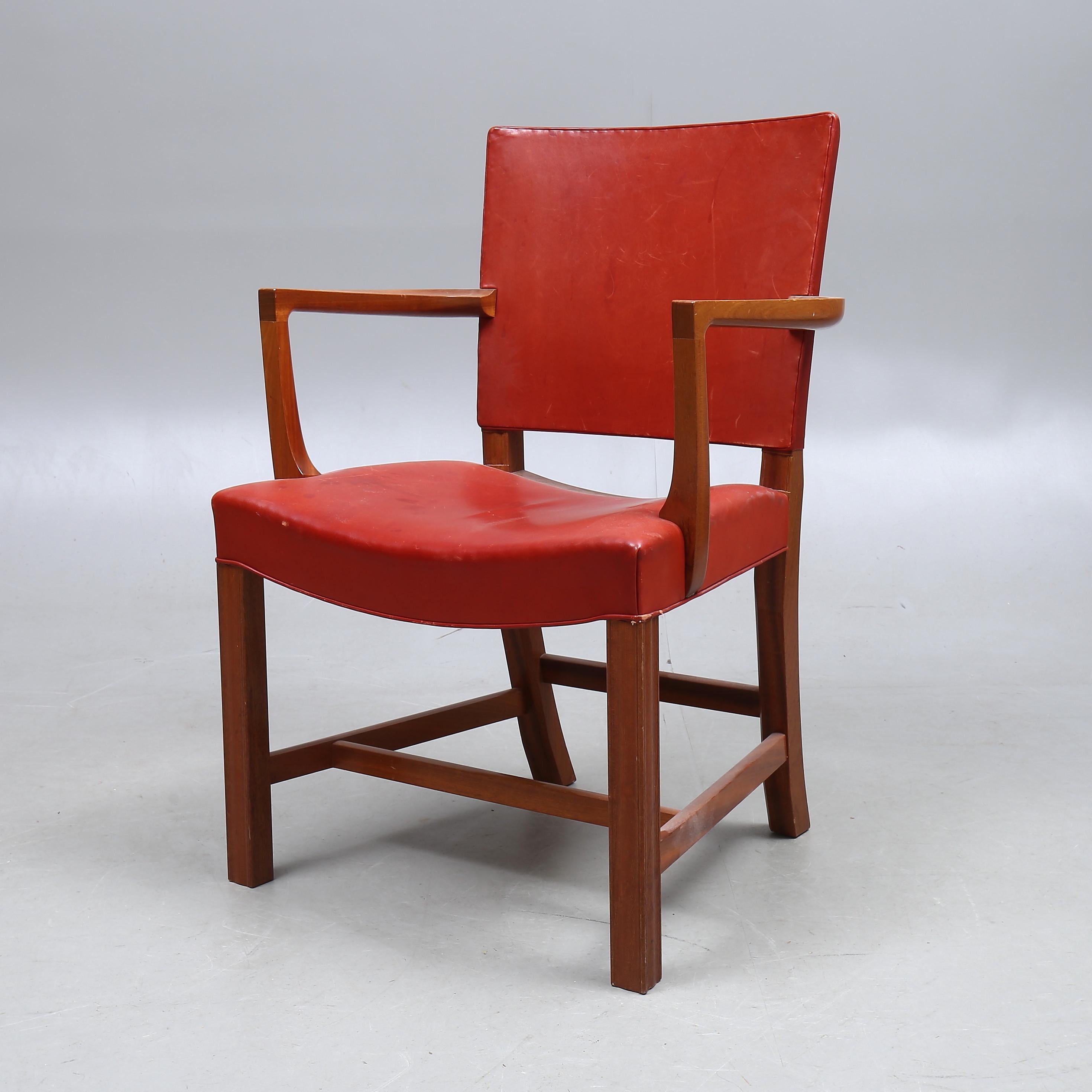 Mahogany frame covered in Indian red leather designed by Kaare Klint in 1927 for the lecture hall of the Danish Museum of Art & Design in Copenhagen and manufactured by Rud Rasmussens.

Ref: Kaare Klint, Harkær, pg. 28-30.
