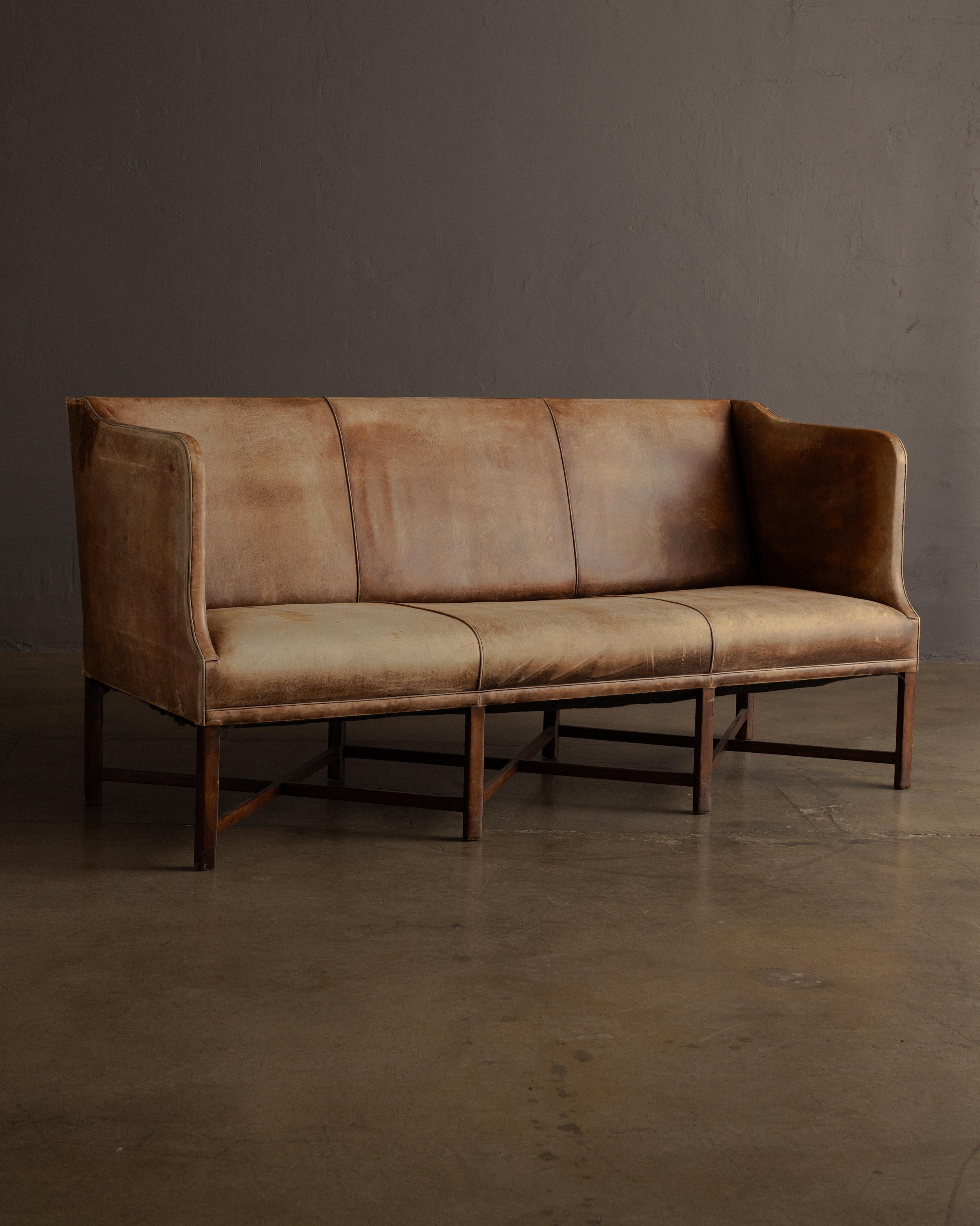 A rare and exceptional three-seat sofa designed by Kaare Klint and produced by Rud. Rasmussen, Copenhagen, in the 1930s. Widely regarded as the father of modern Danish furniture design, Klint created work defined by masterful proportion, functional