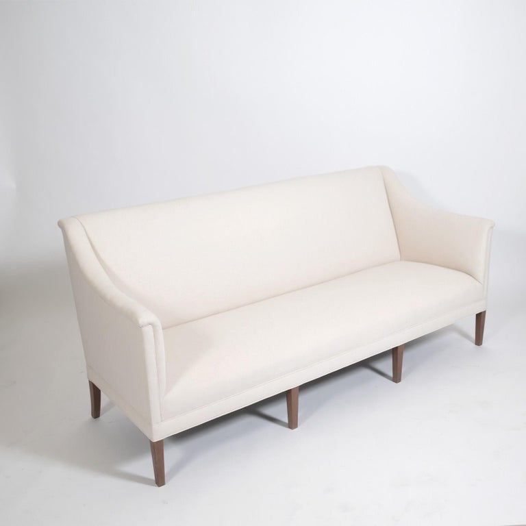 Two available  Kaare Klint sofas design in 1940 for Rud Rasmussen cabinet maker upholstered in muslin.One of the foremost designers of early Danish modern.. Newly reupholstered in off-white. Elegant neo-classical lines make for very comfortable