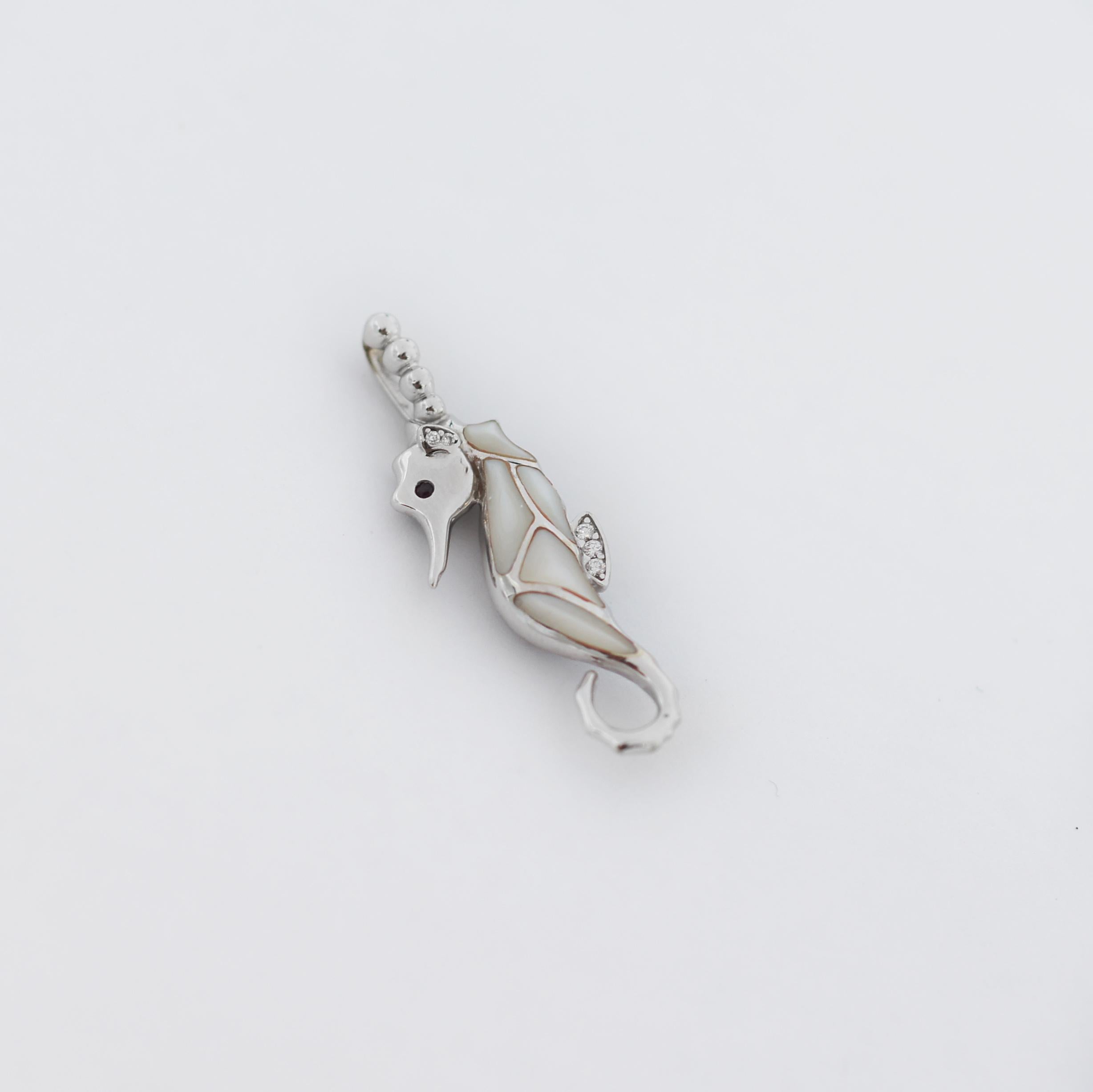 14K Gold
Kabana Seahorse Pendant
White Mother of Pearl Inlay
A Ruby eye
0.02 Carats (total weight) of Diamonds.
The pendant measures approximately 1 1/4
