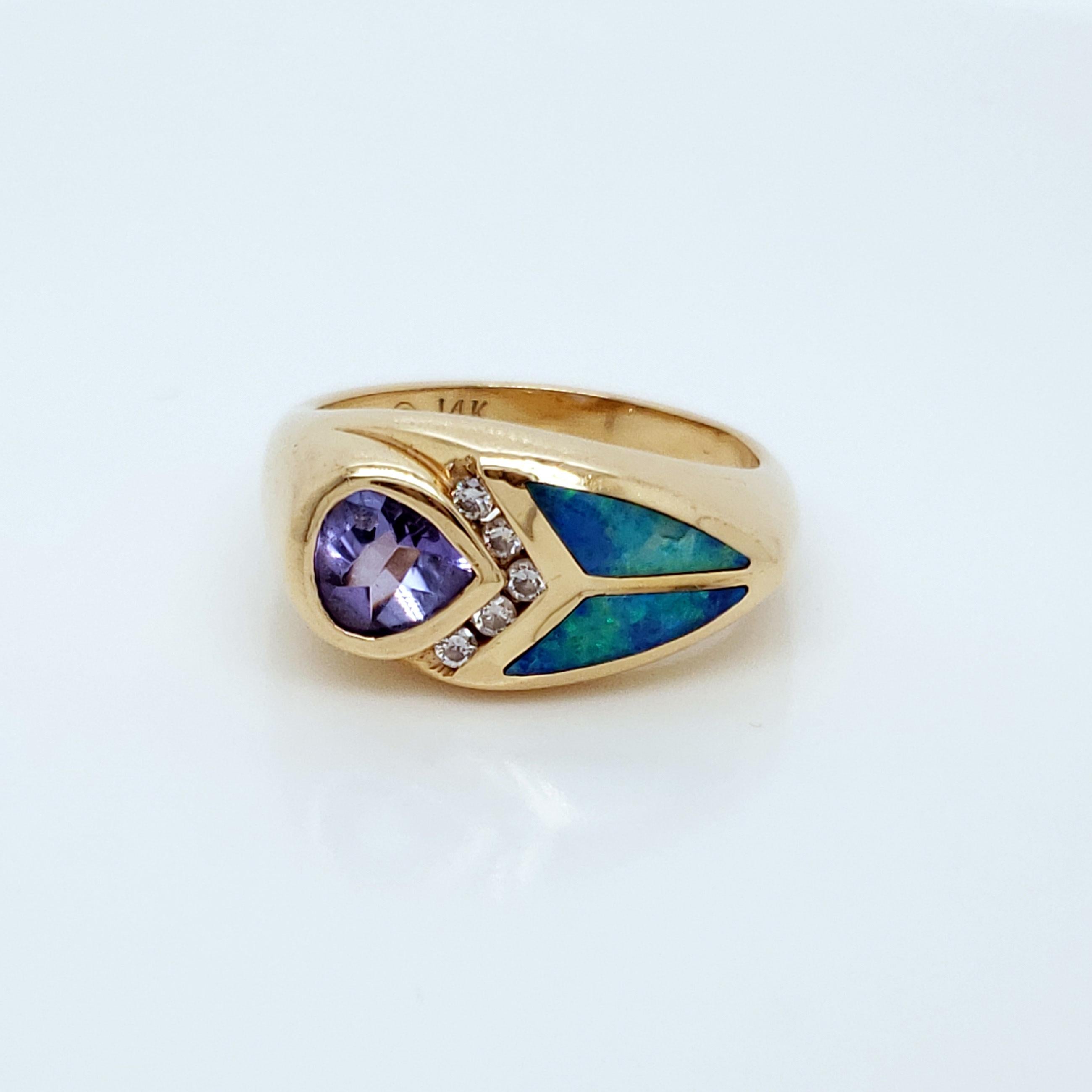 This ring is stunning! The inlaid opal catches the light just right, sending sparkles flying everywhere! Five tiny diamonds, at .075 cttw, are the perfect divide between the gorgeous opal panes and the breathtaking tanzanite! The 6mm periwinkle-hue