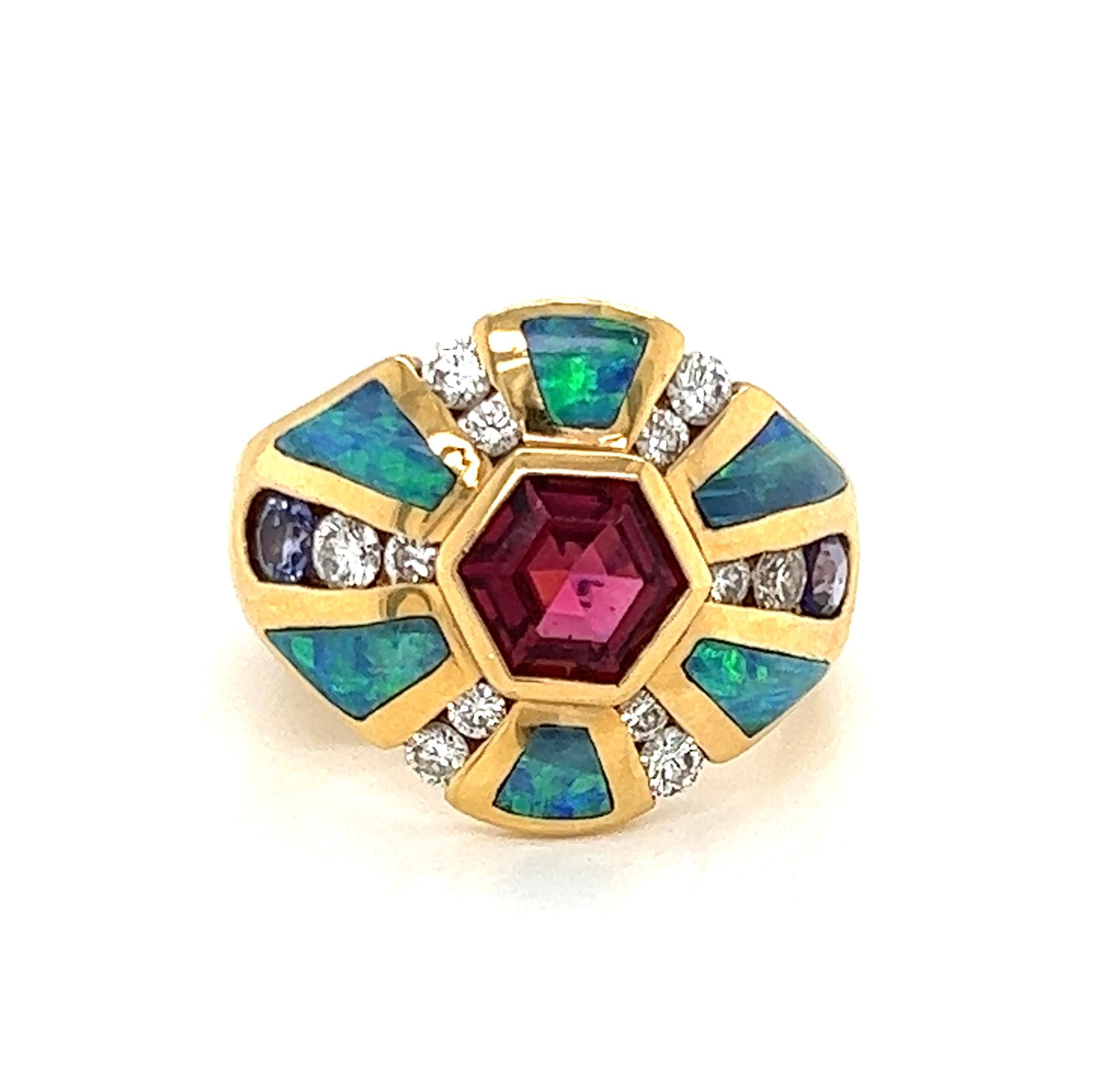 This elegant authentic ring is by Kabana, crafted from 14k yellow gold featuring beautiful design at the front of the ring with an octagonal shape bezel set pink tourmaline in the center and strips of yellow gold set between fire opal inlay with