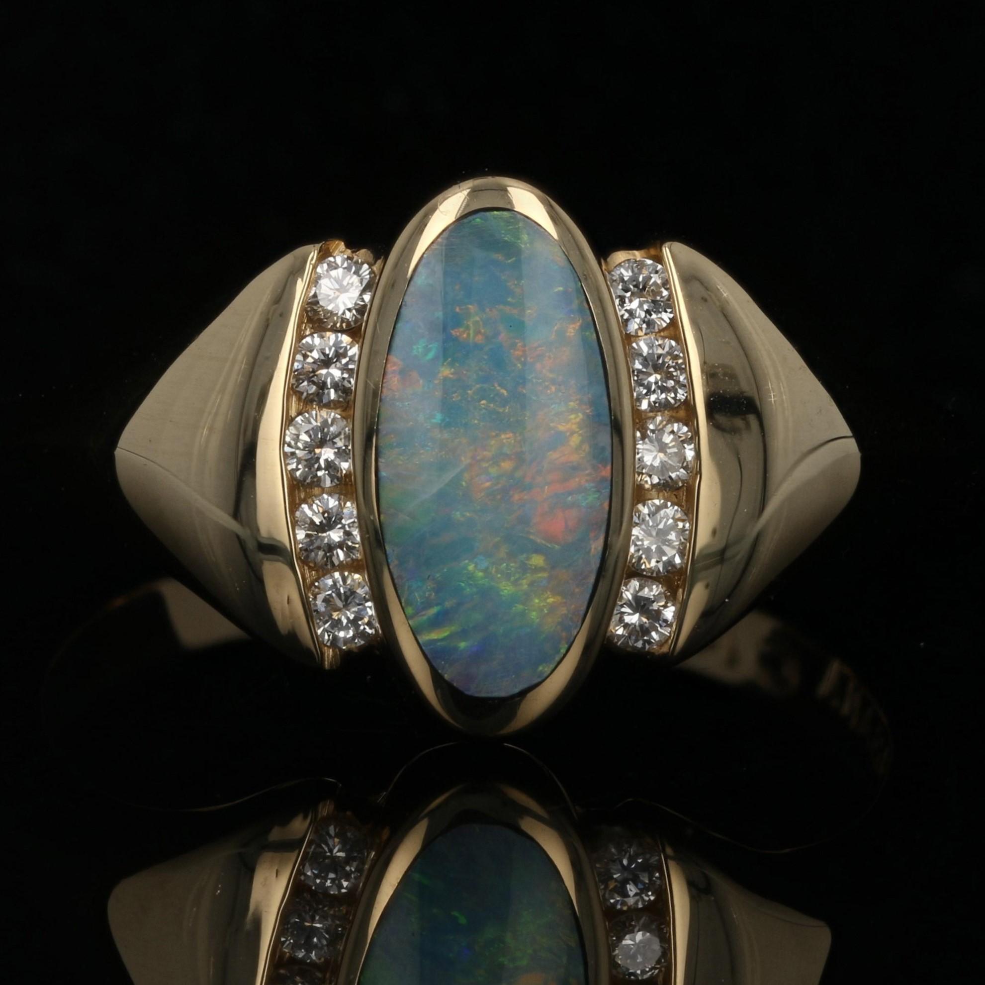 Elegance defined! Fashioned by Kabana in classic 14k yellow gold, this exquisite NEW ring features an inset opal cabochon framed on the sides with crescents of diamonds. Wide shoulders sweep back from the sides to merge into a smoothly polished
