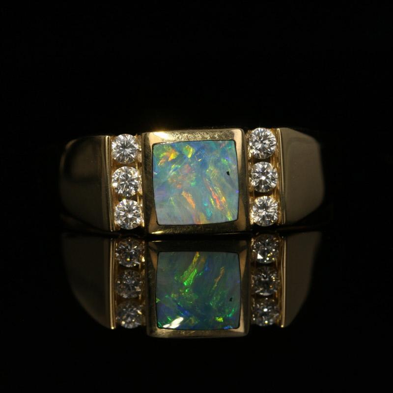 Make this exquisite Kabana ring the highlight of a special birthday or milestone anniversary! Fashioned in classic 14k yellow gold, this NEW piece features an opal in a square, smoothly polished bezel. Six channel-set diamonds on the sides of the