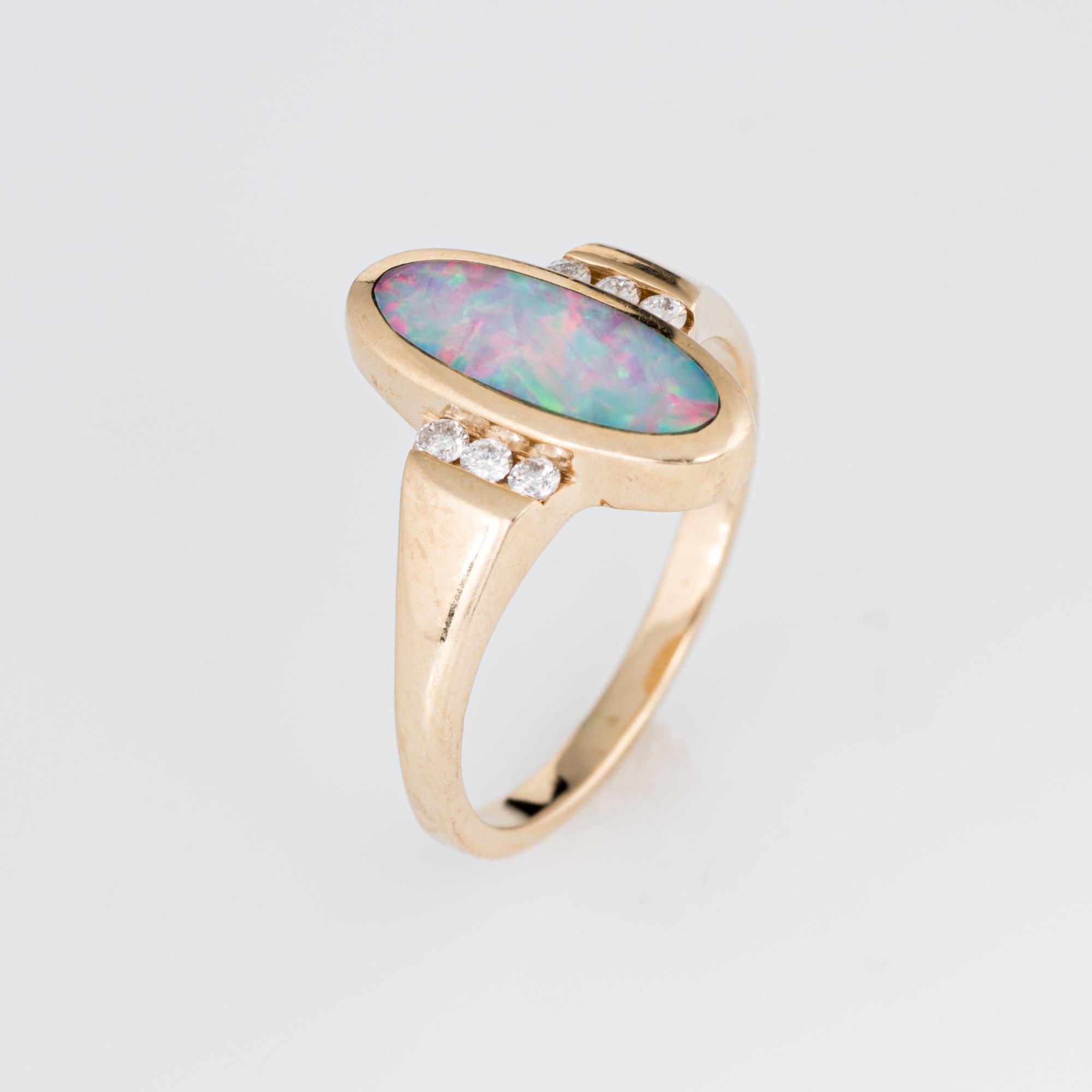 Stylish Kabana opal inlay & diamond ring crafted in 14 karat yellow gold. 

Opal is inlaid into the mount measuring 13mm x 5mm. The diamonds total an estimated 0.06 carats (estimated at G-H color and VS2-SI1 clarity). The opal is in excellent