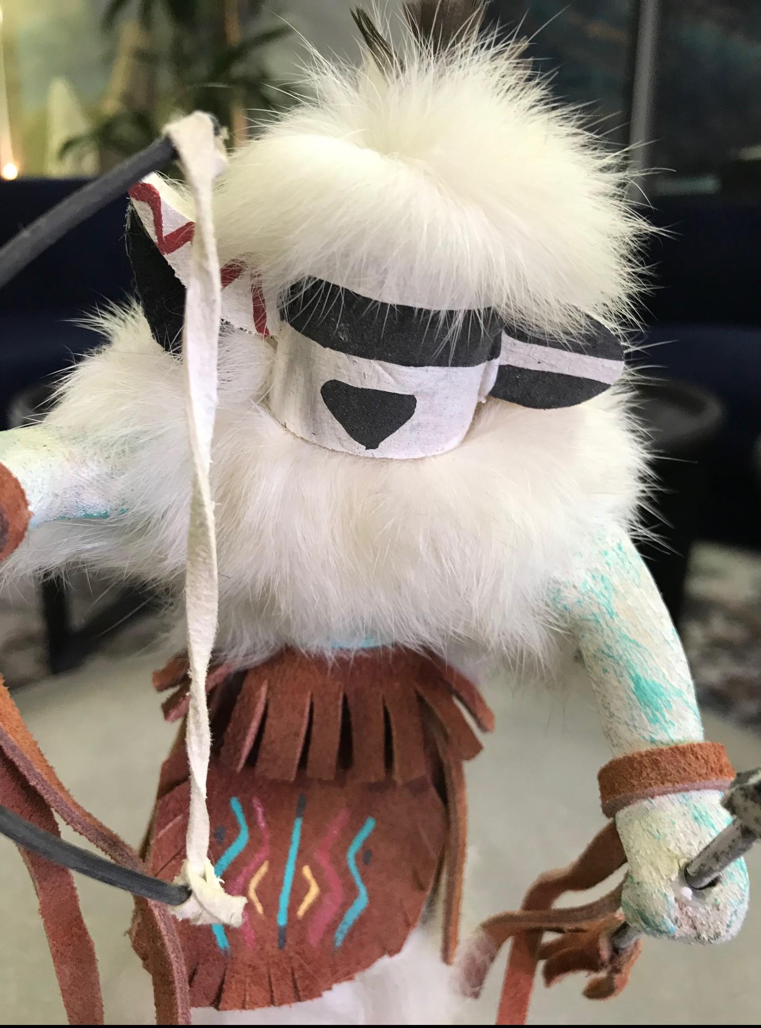 A wonderfully detailed and decorated Kachina doll with white fur.

Signed by the artist on the base.

From a collection of Native American objects and artifacts.

Dimensions: 8
