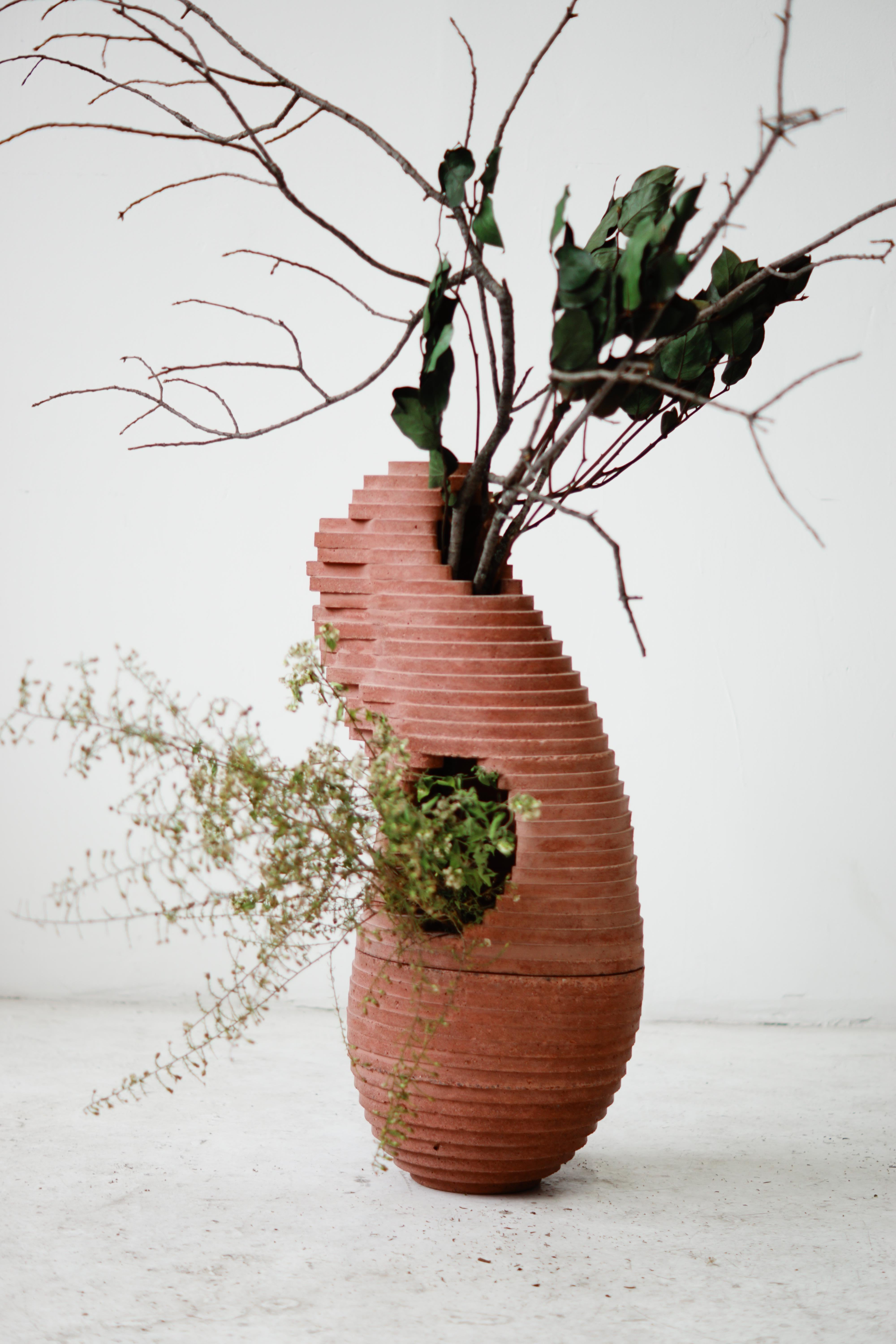 Large Ikebana-style, hand-cast vessel in two parts for indoor and outdoor use.

At the intersection of art, craft, and design, Concrete Poetics' debut collection of hand-cast cement sculptural furniture and accessories streamlines visually