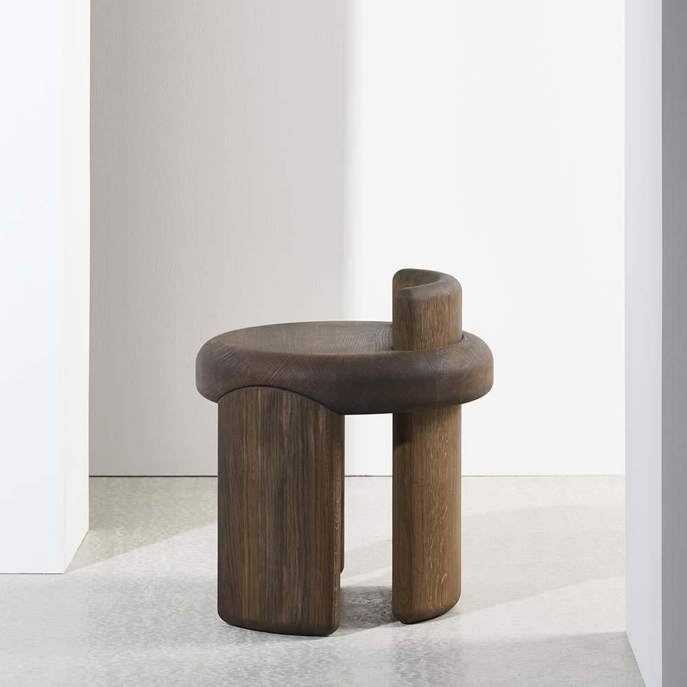 Discover the Kafa stool : a subtle declaration of weight, perfect as a compositional counter-balance or a lone anecdote. 

This oak version is an iconic stool and possesses a firm physicality that is gracefully offset by the contoured focus of its