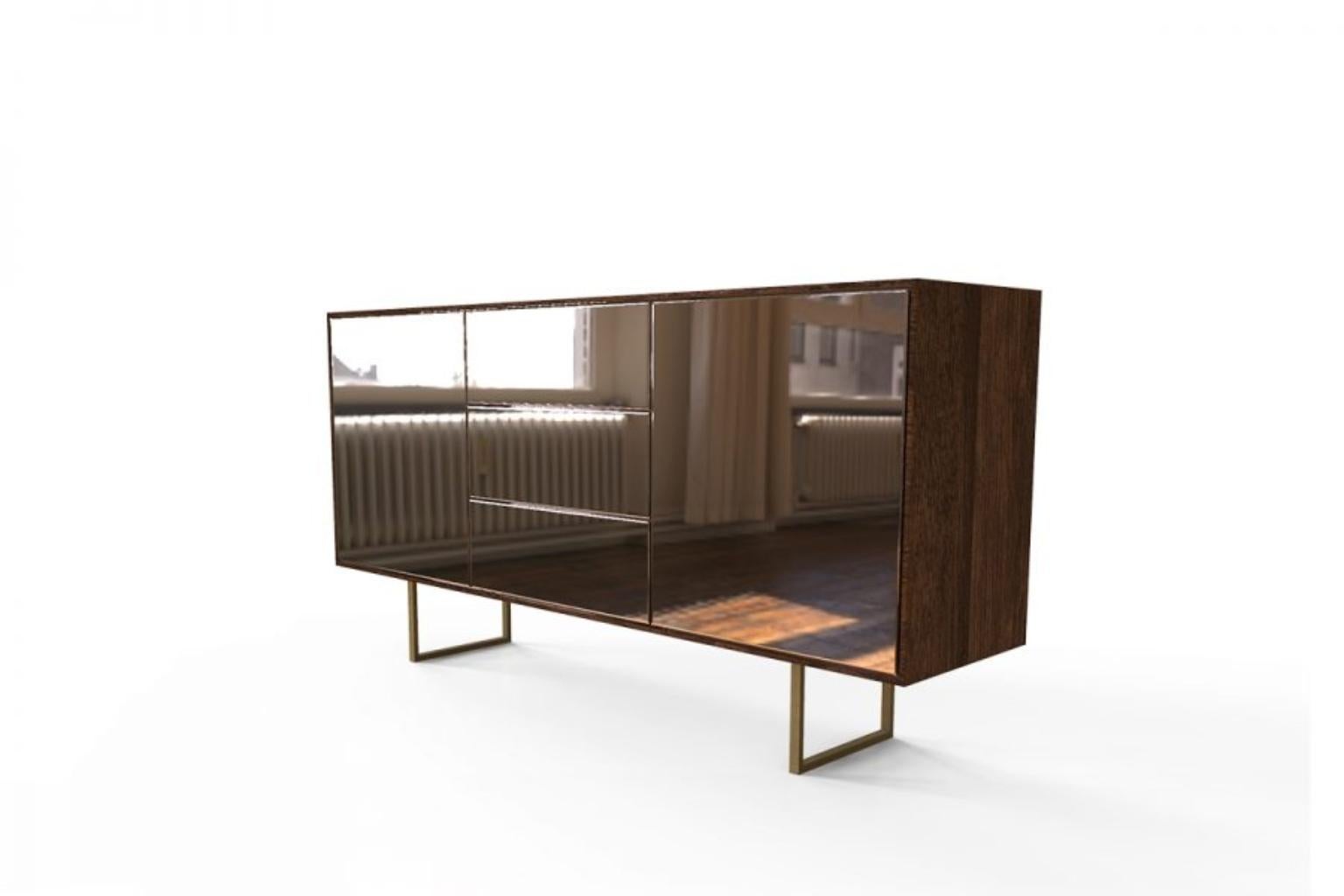 Minimalist Kafe Bronze Mirror Sideboard by Caffe Latte

A Minimalist Kafe Bronze Mirror Sideboard by Caffe Latte, where the clean lines are the main character. Its modern design mixed with oak wood with walnut stain varnish matte, bronze mirror body