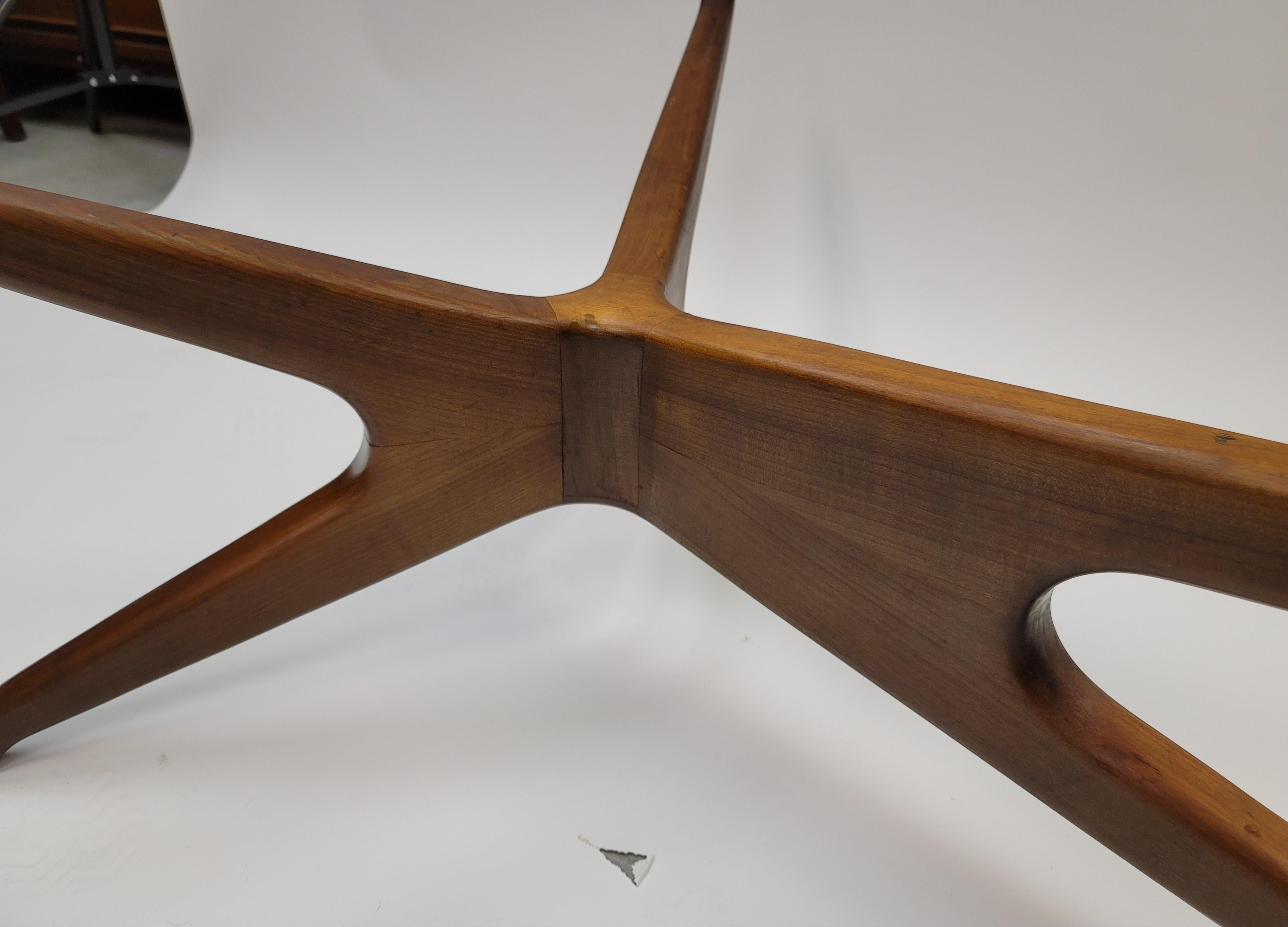 This sculptural wood coffee table with amoeba glass top is inspired by the Vladimir Kagan model 421 table. The carved walnut base support the quality 0.5