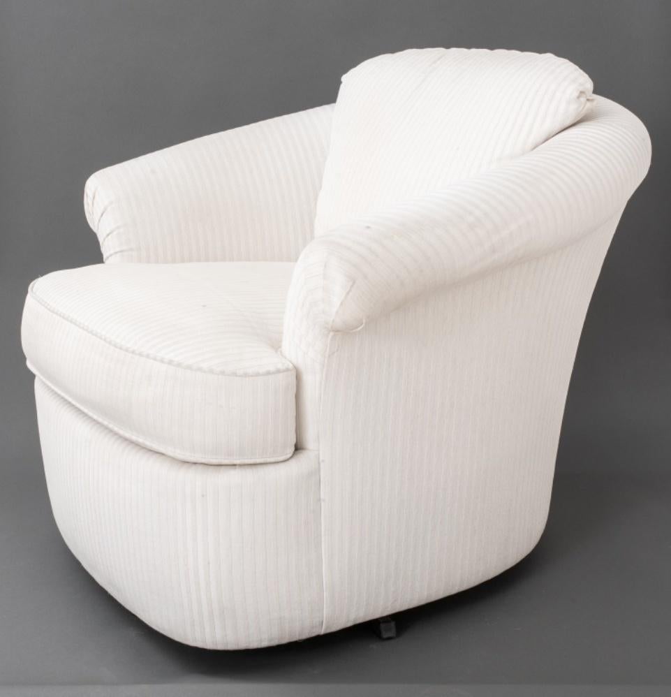 Modern swivel armchair with cream upholstery in the manner of Vladimir Kagan (American, 1927-2016). Measures: 27