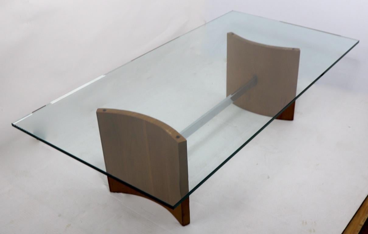 Vladimir Kagan design for Selig Propeller coffee table. Base consists of opposing curved Walnut veneer elements joined by a rectangular chrome support. Base without glass top 14 inch H x 15 deep x 36 W. Plate glass top .50 inch thick x 28 D x 54 W.