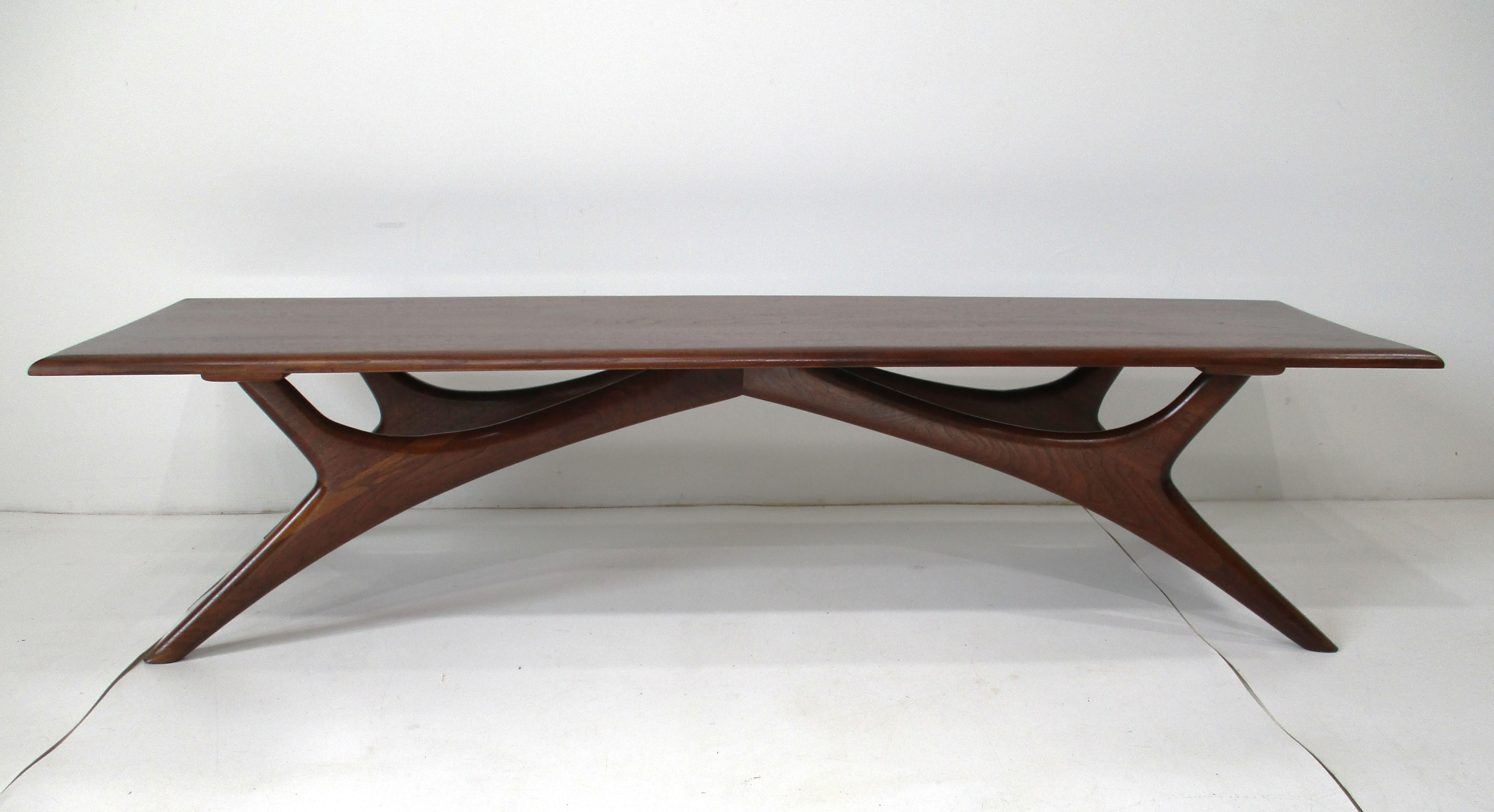 A very well hand-crafted walnut coffee table with sculptural legs. This unique piece would make a statement in any room and can be mixed with any style of interior. Manufactured and designed by Josef Otmar known for his attention to details and his