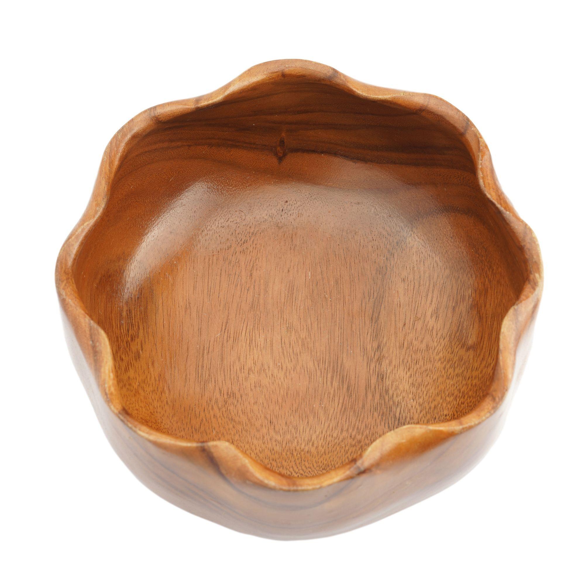 Hand turned & carved eight lobe bowl of native Hawaiian monkeypod wood. The bowl features a carved rim of eight tapered edge scollops on a flat based bowl. 
Labeled on the underfoot: Kahana Woods, Monkeypod, Kahana Traders Ltd, Honolulu,