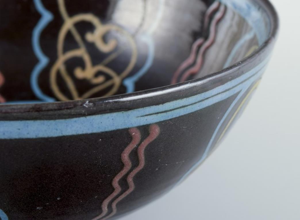 Glazed Kähler. Ceramic bowl. Polychrome glaze on a black base. Circa 1930s. For Sale