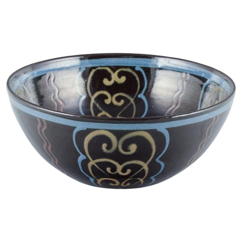Kähler. Ceramic bowl. Polychrome glaze on a black base. Circa 1930s.