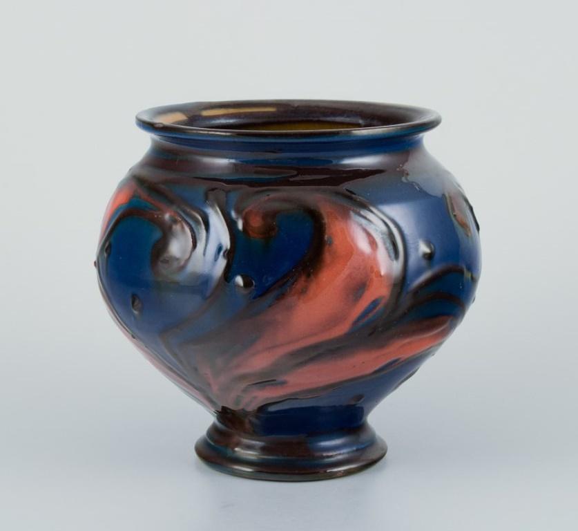 Danish Kähler ceramic vase in cow horn technique. Glaze in blue and orange tones. For Sale