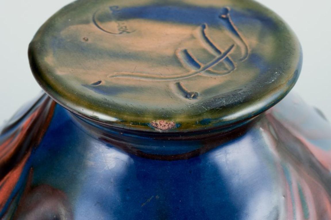 Mid-20th Century Kähler ceramic vase in cow horn technique. Glaze in blue and orange tones. For Sale