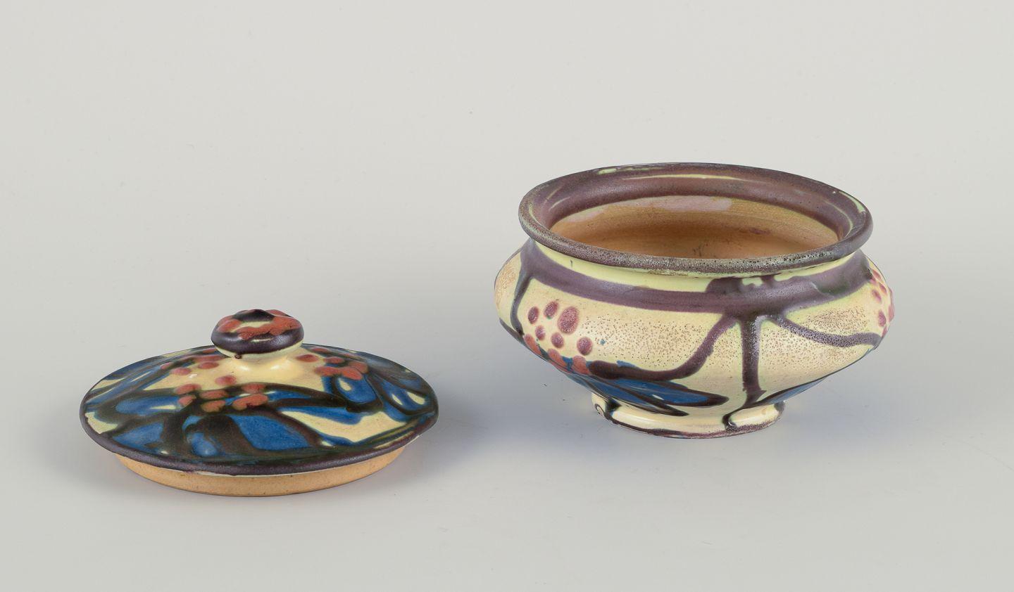 Pre-owned goods are exempt from import duties for U.S. customers. 
Therefore, no import tariffs will be applicable to your purchase.

Kähler, Denmark. Ceramic bonbonniere decorated with flowers. 
Cow horn technique.
Blue, brown, and ochre yellow