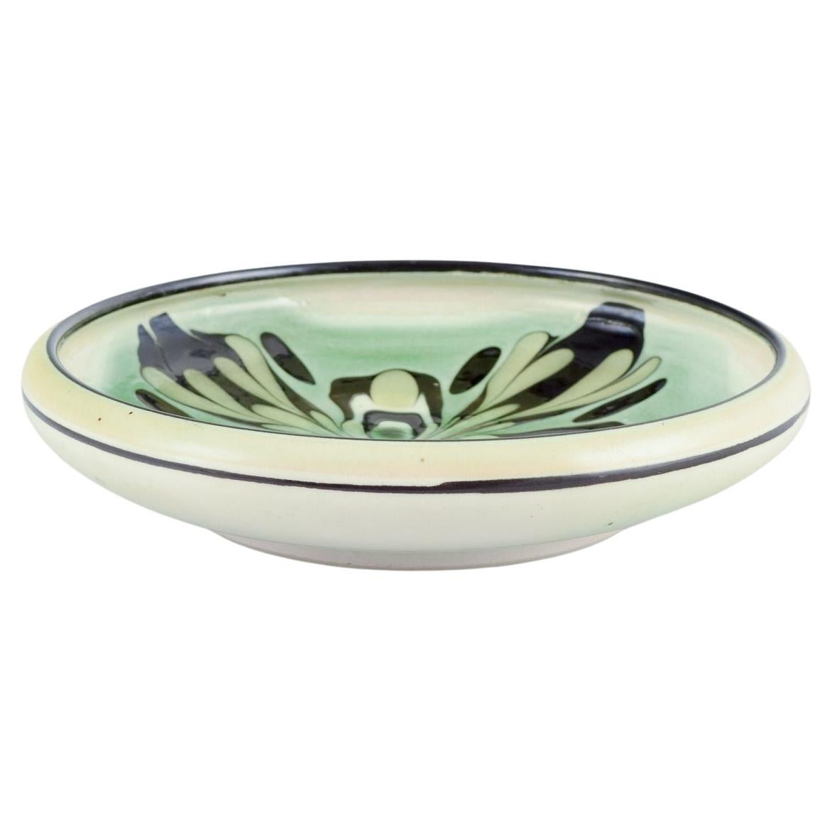 PRE-OWNED GOODS ARE EXEMPT FROM IMPORT TARIFFS FOR U.S., UK, AUSTRALIAN & CANADIAN CUSTOMERS.   
THEREFORE, NO IMPORT TARIFFS WILL BE APPLICABLE TO YOUR PURCHASE. 

Kähler, Denmark.
Ceramic bowl with floral motif. Glaze in green and black