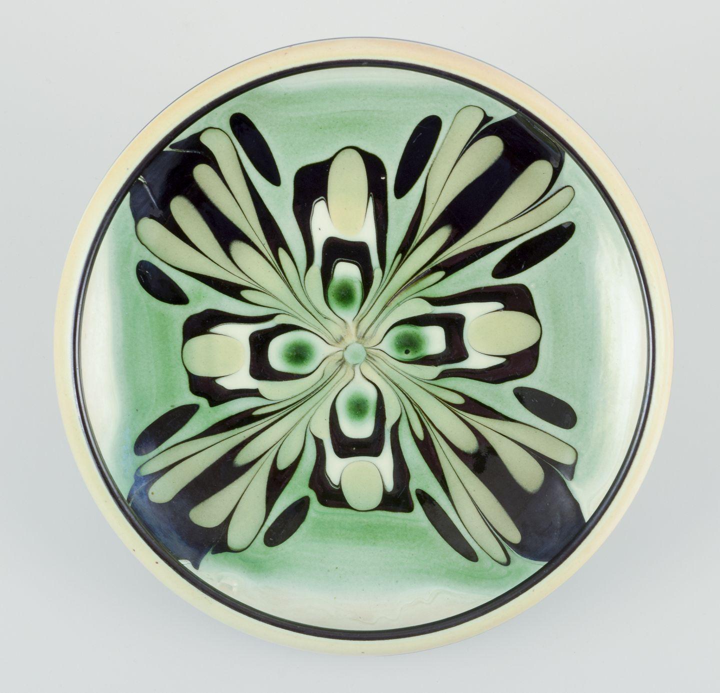 Danish Kähler, Denmark. Ceramic bowl with floral motif. Glaze in green and black tones. For Sale