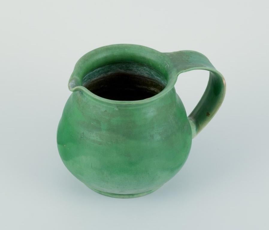 Danish Kähler, Denmark. Ceramic pitcher. Glaze in green tones. Approx. 1930/40s. For Sale