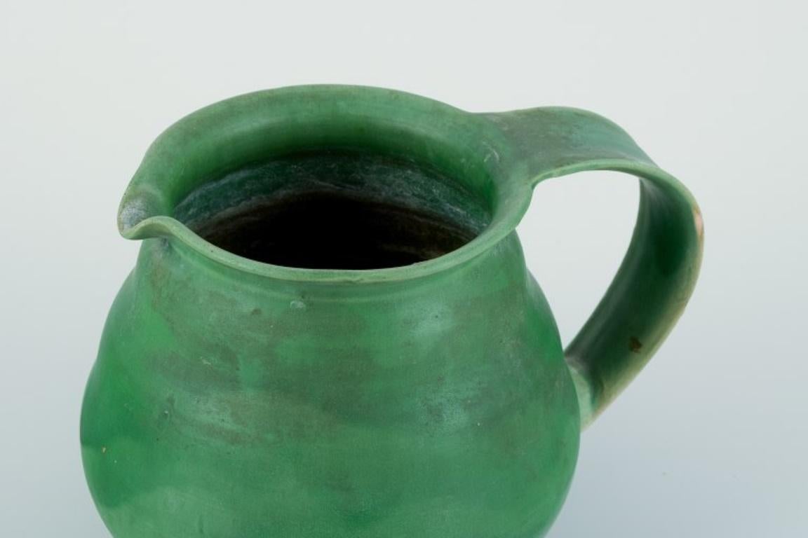 Glazed Kähler, Denmark. Ceramic pitcher. Glaze in green tones. Approx. 1930/40s. For Sale