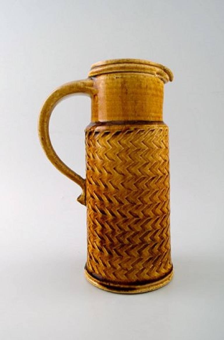 Kähler, Denmark, glazed stoneware jug. Designed by Nils Kähler, 1960s.
Brown and dark yellow glaze.
In perfect condition.
Stamped.
Measures: 22 cm.
