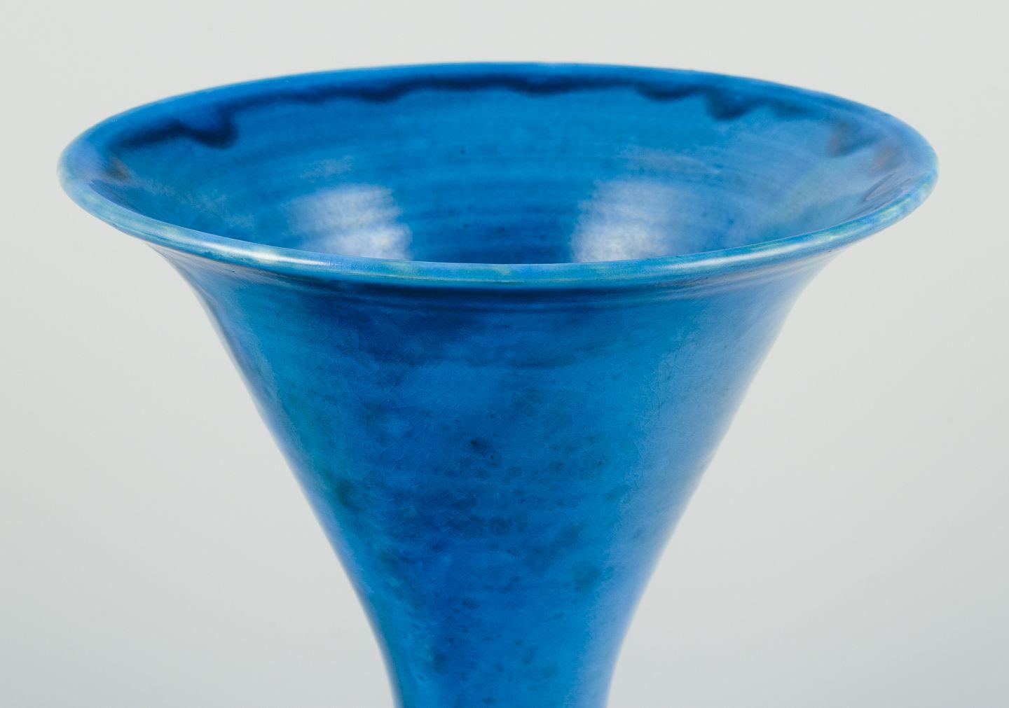 Pre-owned goods are exempt from import duties for U.S. customers. 
Therefore, no import tariffs will be applicable to your purchase.

Kähler, Denmark.
Trumpet-shaped ceramic vase, turquoise glaze.
Handmade.
Circa 1940s.
Marked.
In perfect