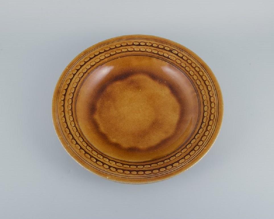 Kähler, HAK, glazed colossal stoneware bowl.
Designed by Nils Kähler. 
Uranium yellow glaze.
1960s.
In excellent condition.
Signed.
Dimensions: D 40.5 x H 5.5 cm.