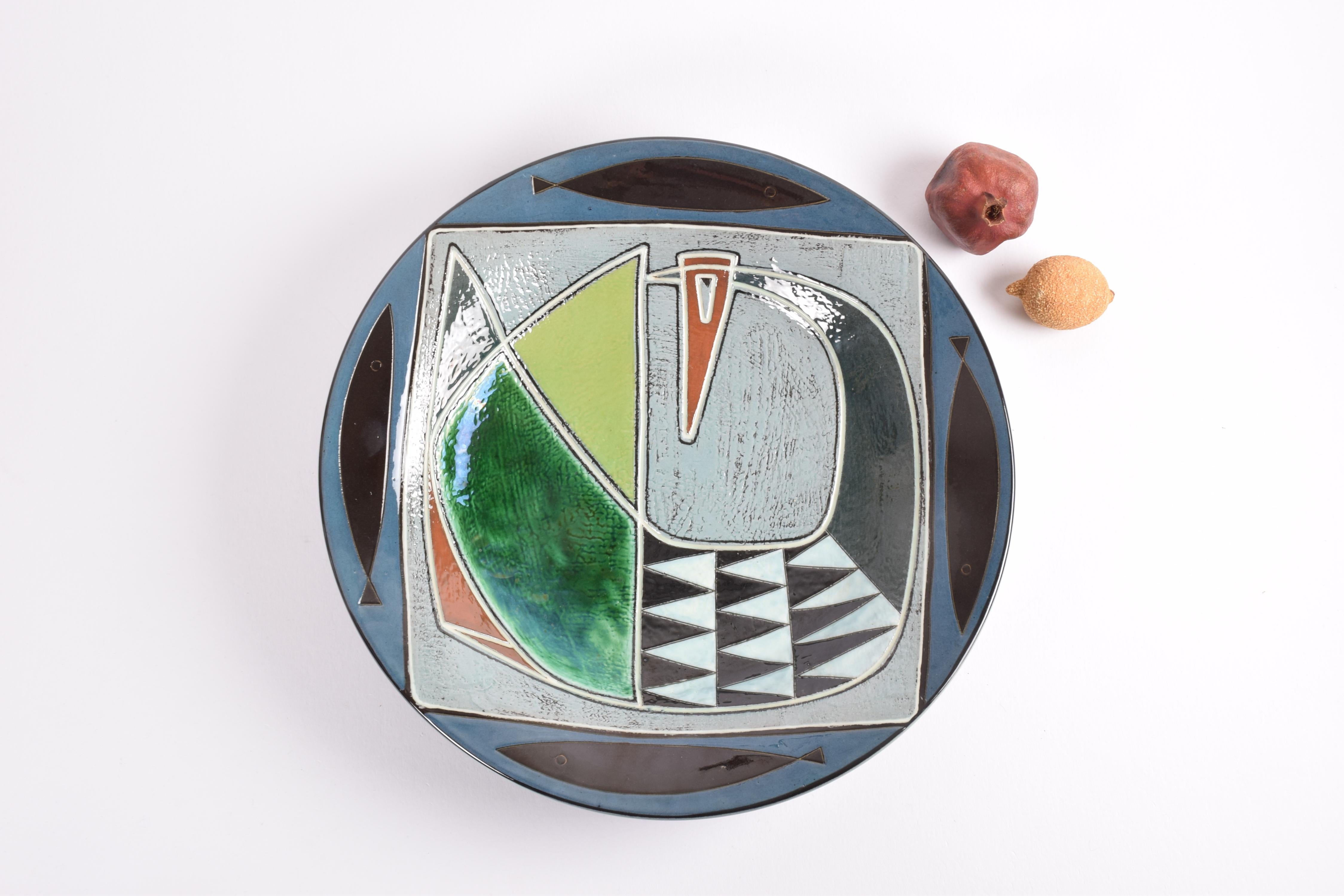 Huge platter by Gete Petersen for Kähler´s ceramic workshop in Denmark.
The decor shows a large stylised bird in center surrounded by four stylised fishes. 

The platter can be used as a display piece on the table. For hanging on the wall you