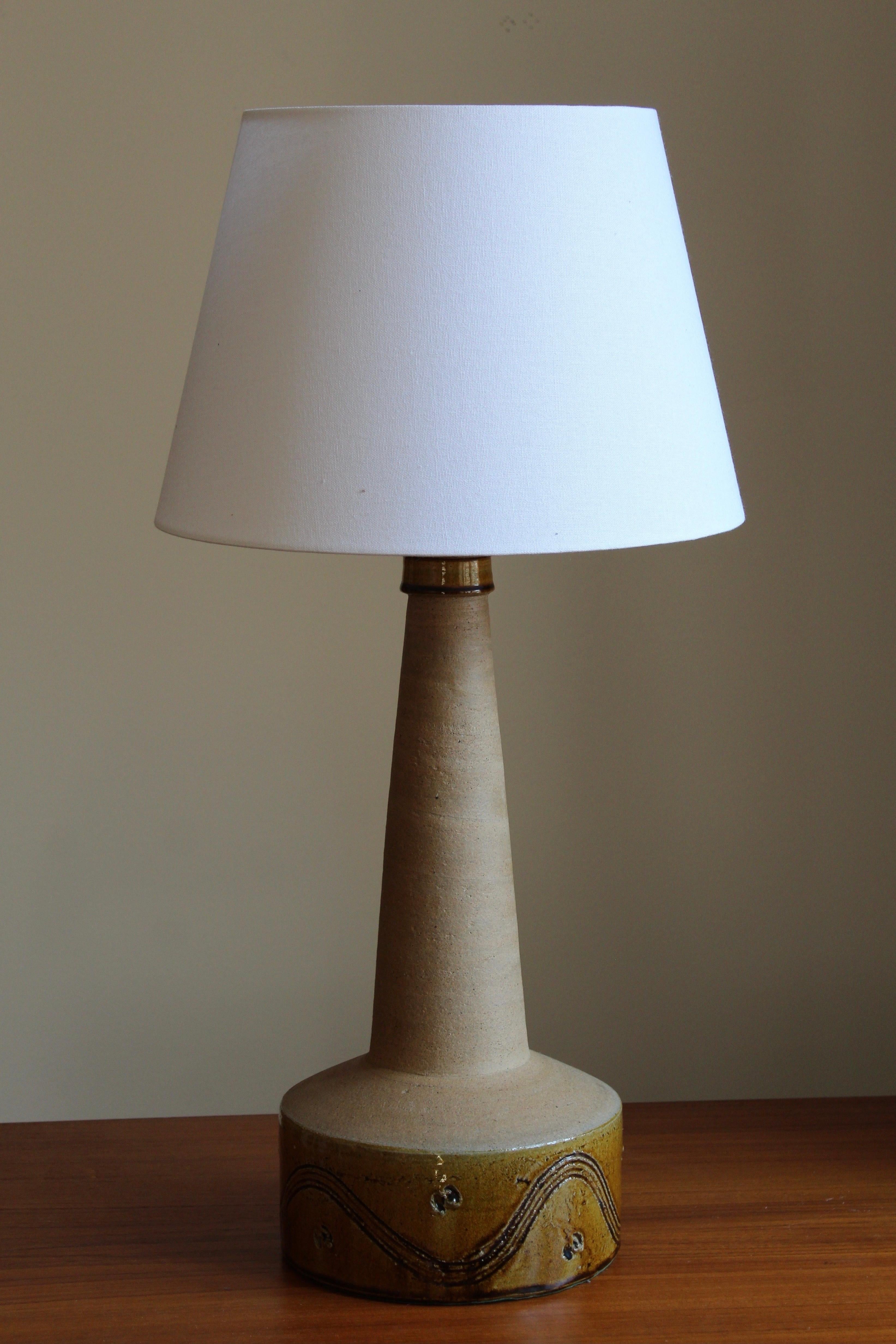 A large table lamp, designed and produced by Kähler, Denmark, c. 1930s. 

Glaze features brown-yellow-grey colors.

The lampshade is not included, stated dimensions are excluding lampshade.

