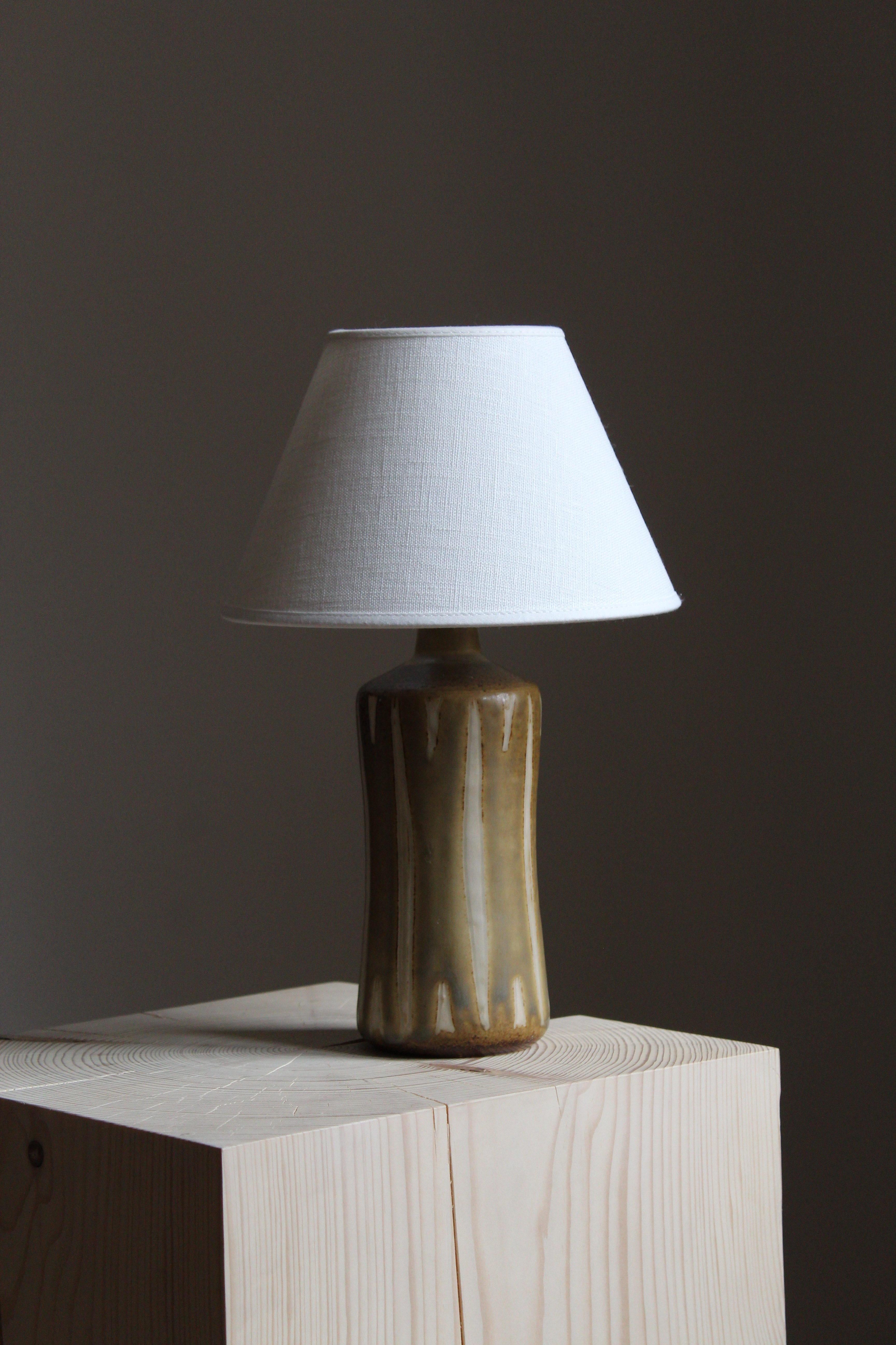 A table lamp, designed and produced by Kähler, Denmark, 1950s. Lampshade not included.

Glaze features green-brown-yellow-grey colors.

Other designers of the period include Axel Salto, Arne Bang, Upsala Ekeby, Saxbo, and Carl Harry Stålhane.