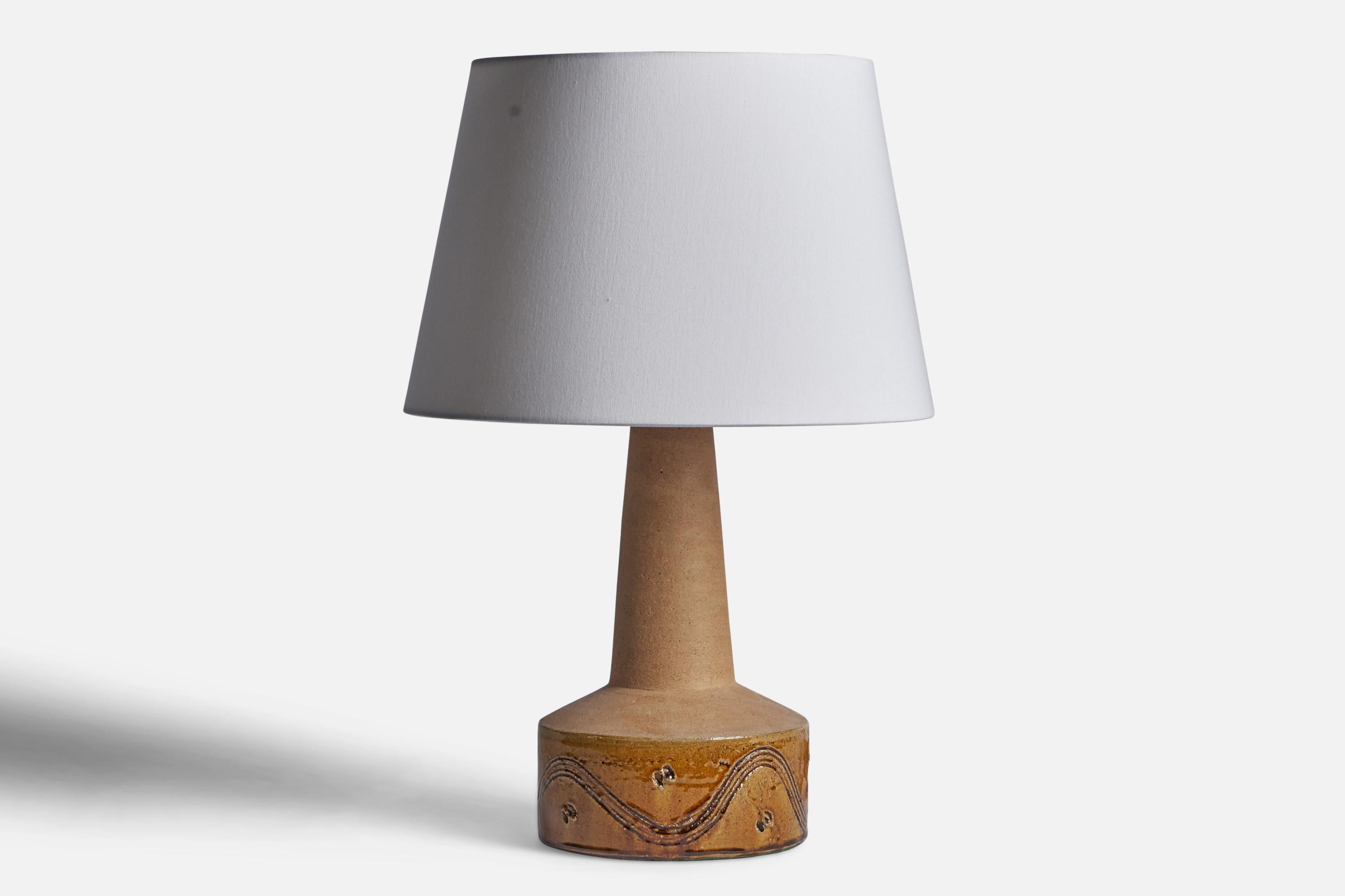 A beige semi-glazed ceramic table lamp designed and produced by Kähler, Denmark, c. 1940s.

Dimensions of Lamp (inches): 20.75” H x 8.75” Diameter
Dimensions of Shade (inches): 12” Top Diameter x 16” Bottom Diameter x 10.9” H
Dimensions of Lamp with
