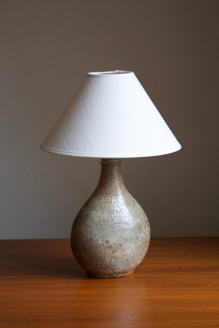 A large table lamp, designed and produced by Kähler, Denmark, c. 1930s. Sold without lampshade.

Glaze features a grey color with hints of brown.