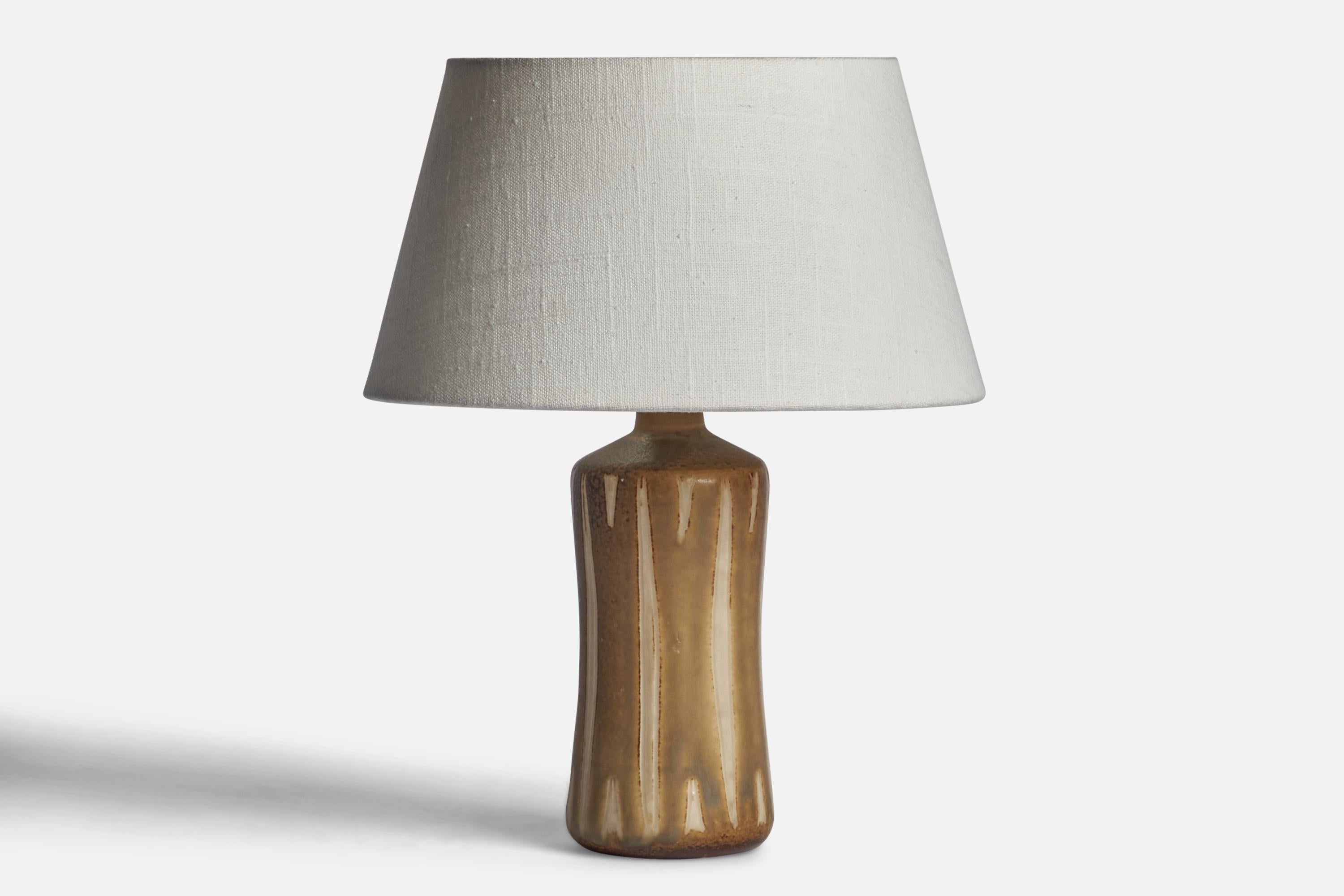 A brown and beige-glazed stoneware table lamp designed and produced by Kähler, Denmark, c. 1960s.

Dimensions of Lamp (inches): 10.05” H x 3.25” Diameter
Dimensions of Shade (inches): 7” Top Diameter x 10” Bottom Diameter x 5.5” H 
Dimensions of