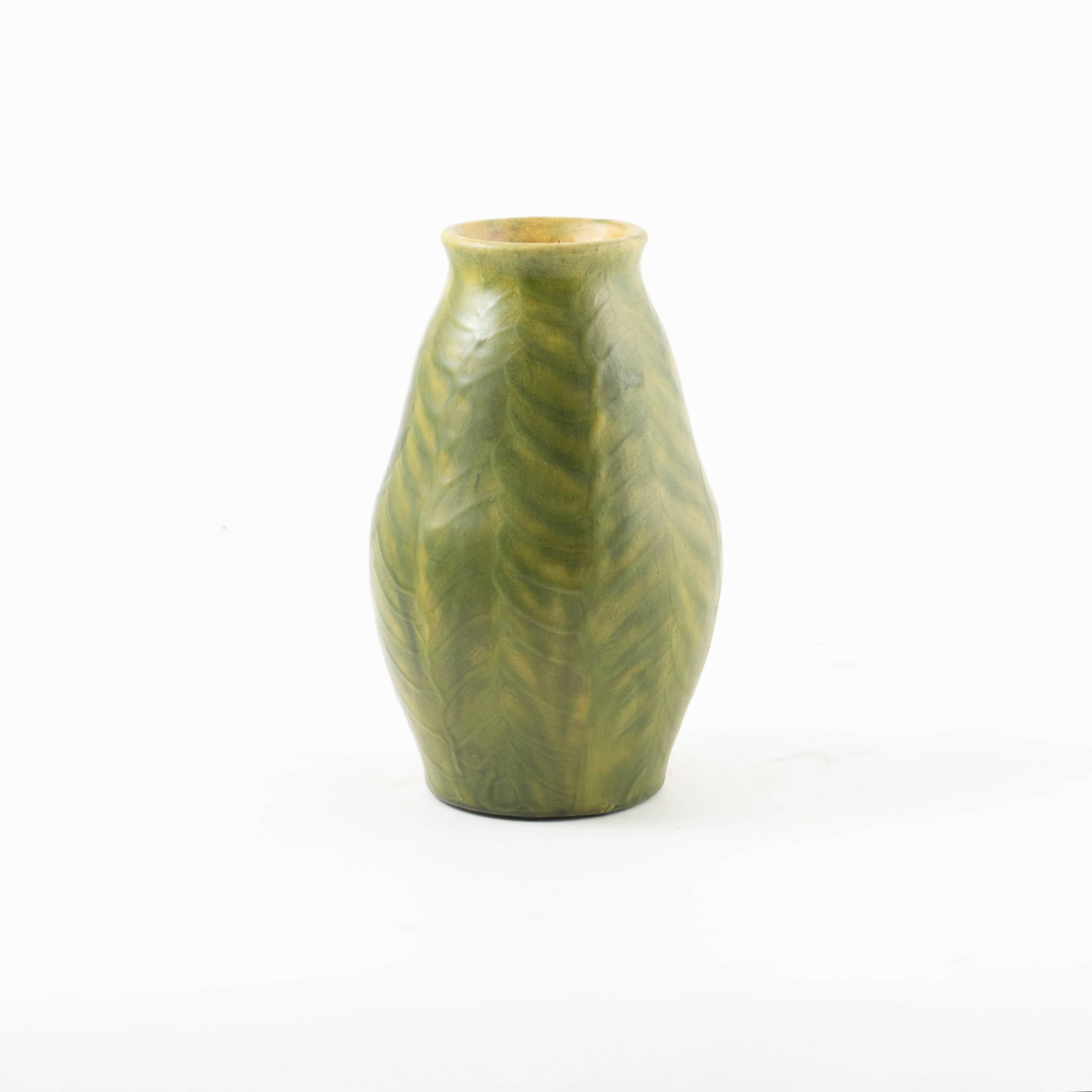 Glazed stoneware vase.
Green leaves on a yellow background.
Signed HAK

Denmark 1920-1930.