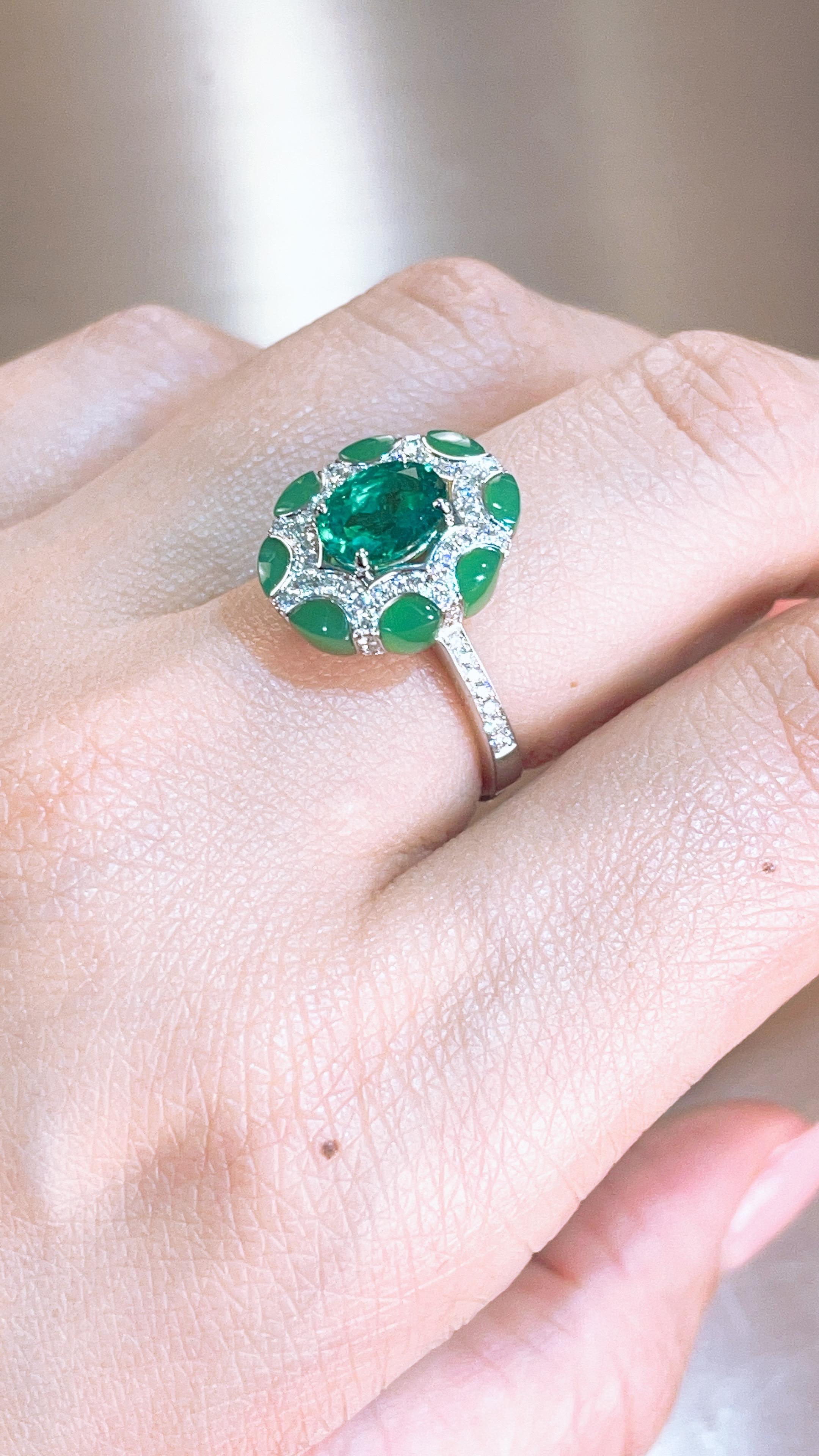 This ring presents a 1.11 carat cut Colombia Emerald set with white diamond and Chrysoprase which is a very special piece that we make recently after pink sapphire and blue sapphire,  finished in white gold. 
This piece comes with GIA certificate