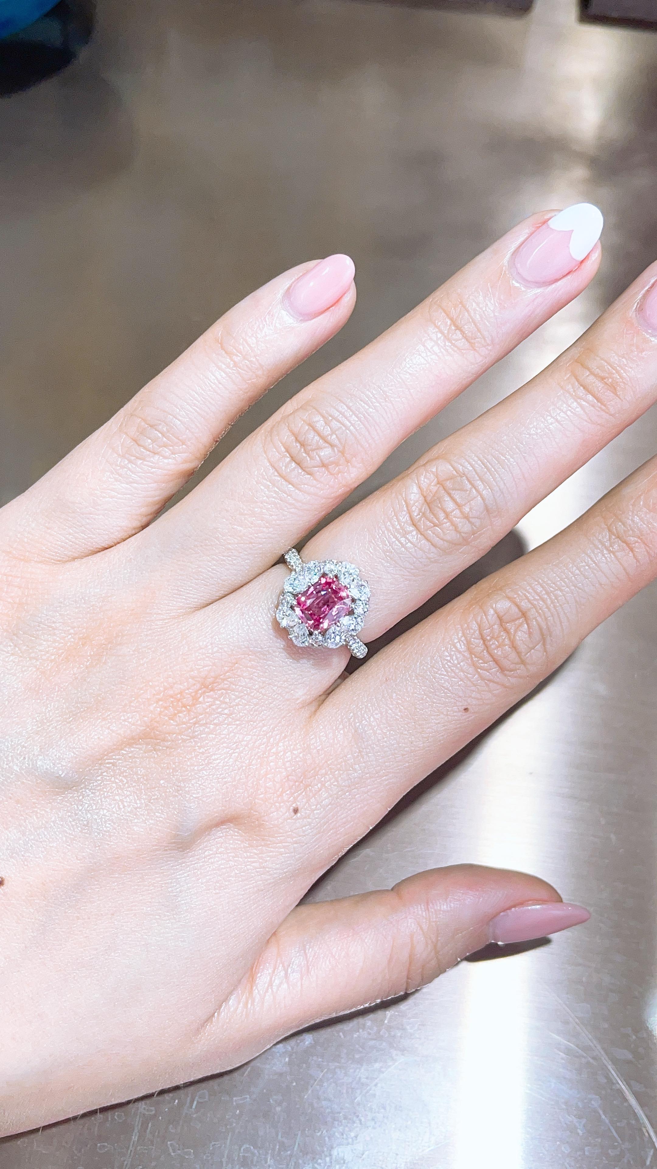 This ring present a 2.06 carat unheated long cushion cut Pink sapphire set with 8 per shape white diamond around. finished in 18K white gold, and total white diamond 1.81ct . 

The stone is absolutely clean and with vibrant pink color. 

This piece