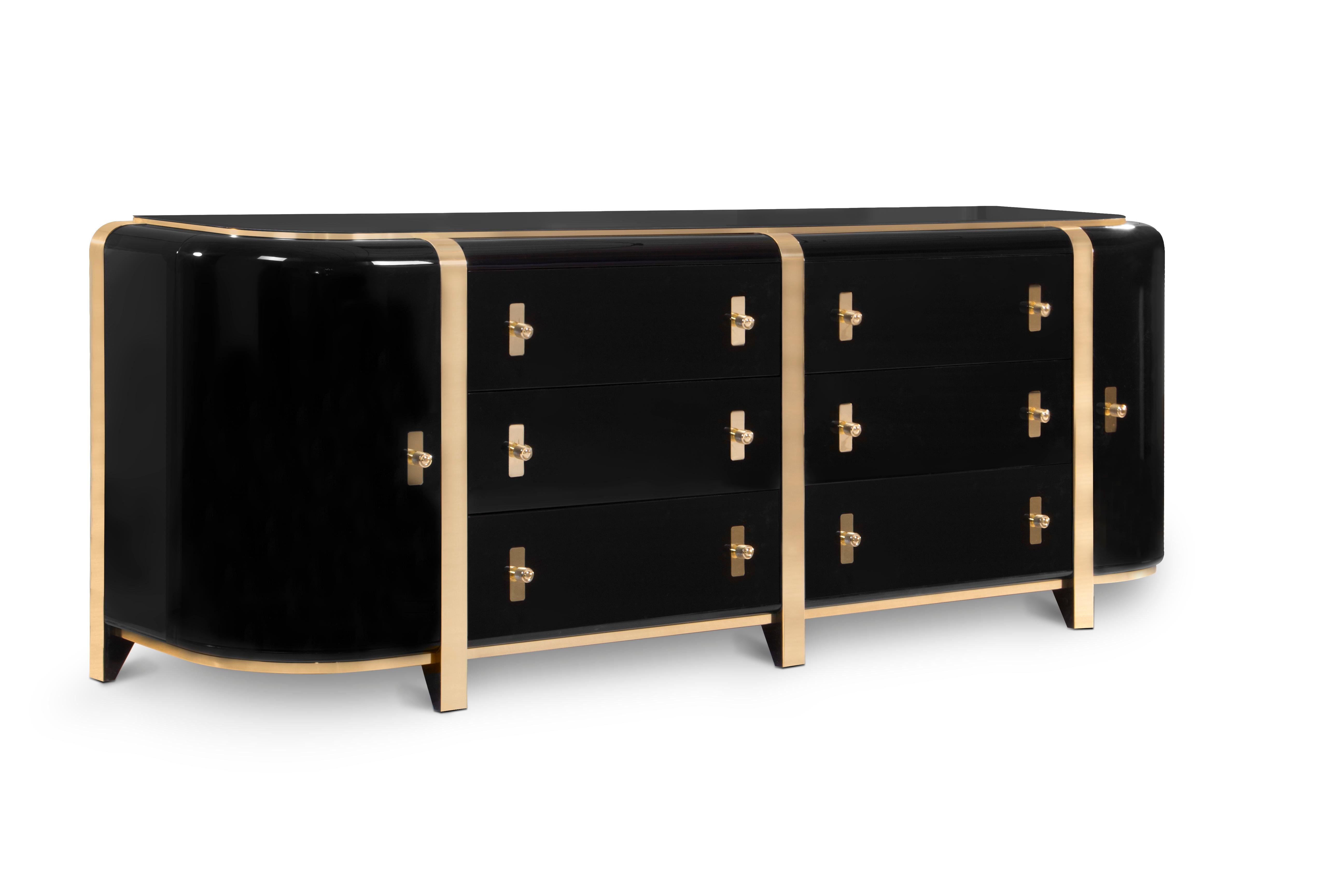 A sideboard with a strong presence while preserving clean lines. Kahn is inspired by Louis Kahn’s monumental and monolithic style. Large brass details envelop the glossy black body while the black glass top adds a luxurious layer to the design. The